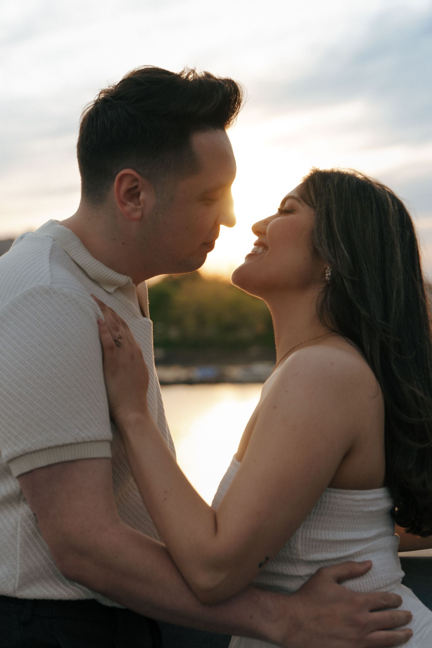 Intimate couple's portrait session at sunset by the waterfront.