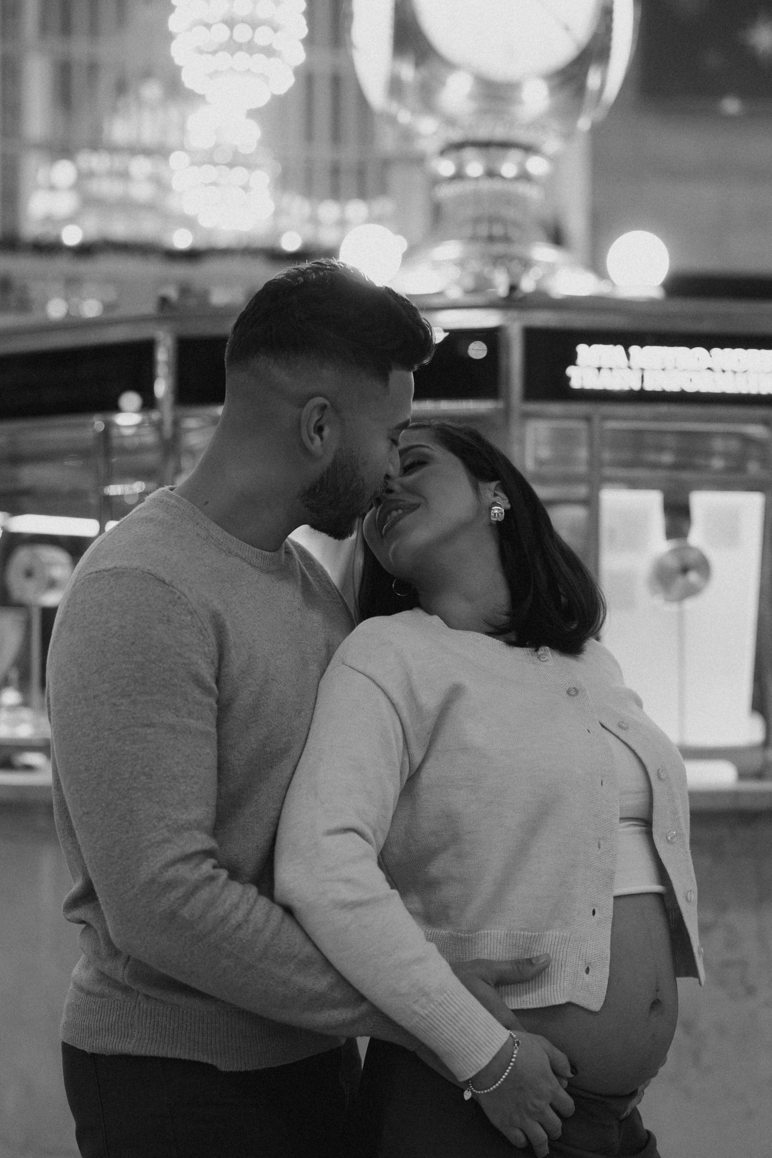 A black and white photo sequence shows a couple embracing and kissing in a dimly lit setting.