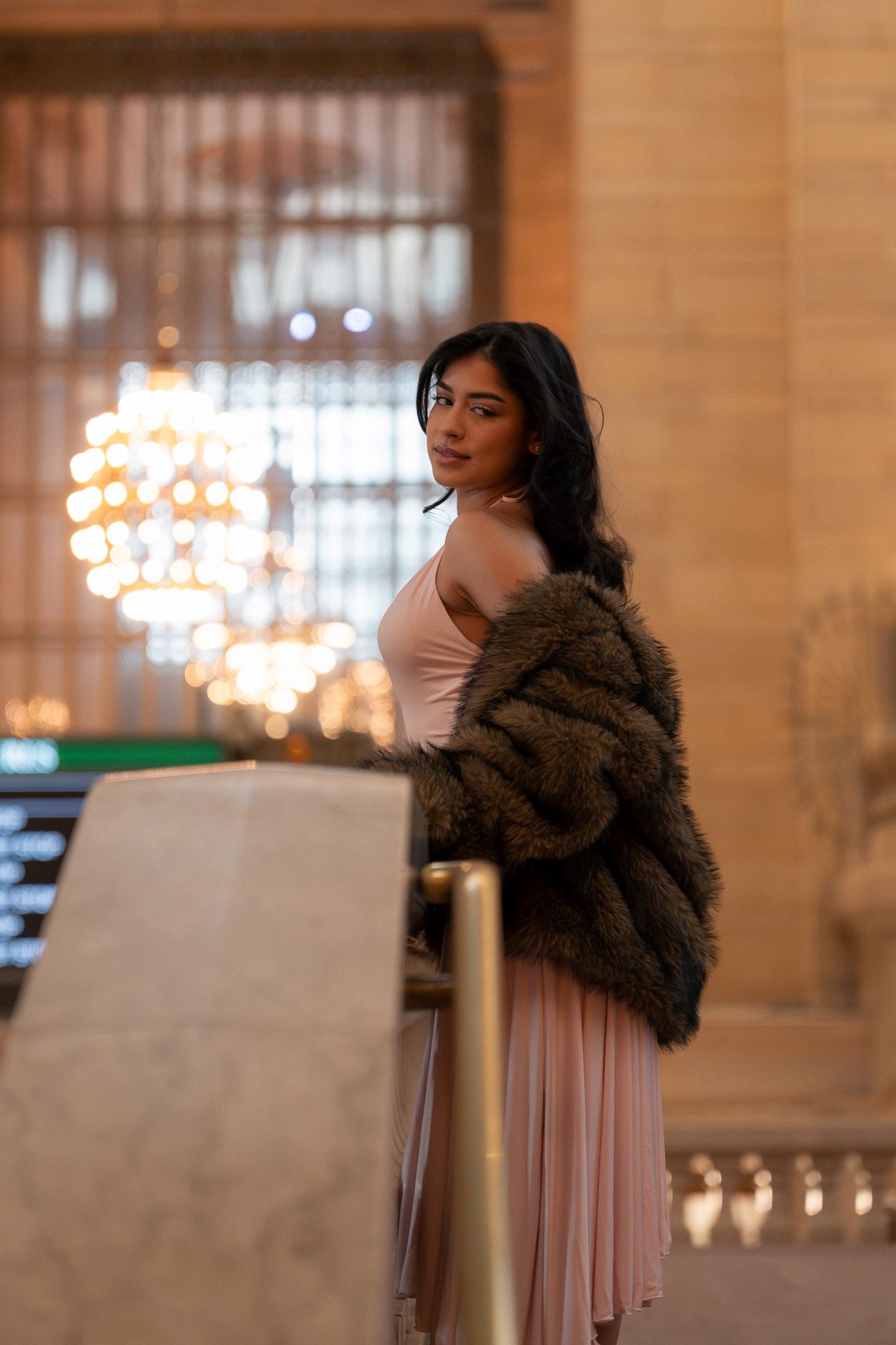A series of portraits in an elegant indoor setting with warm lighting and chandeliers in the background.