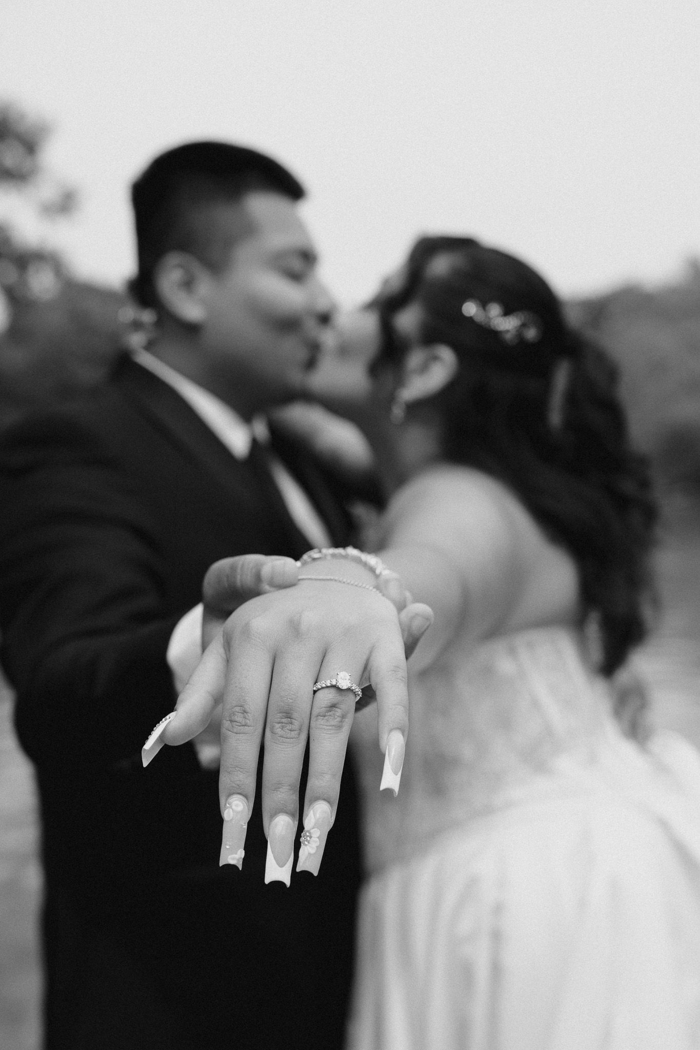Close-up shot of a bride's hand showing off wedding ring details.