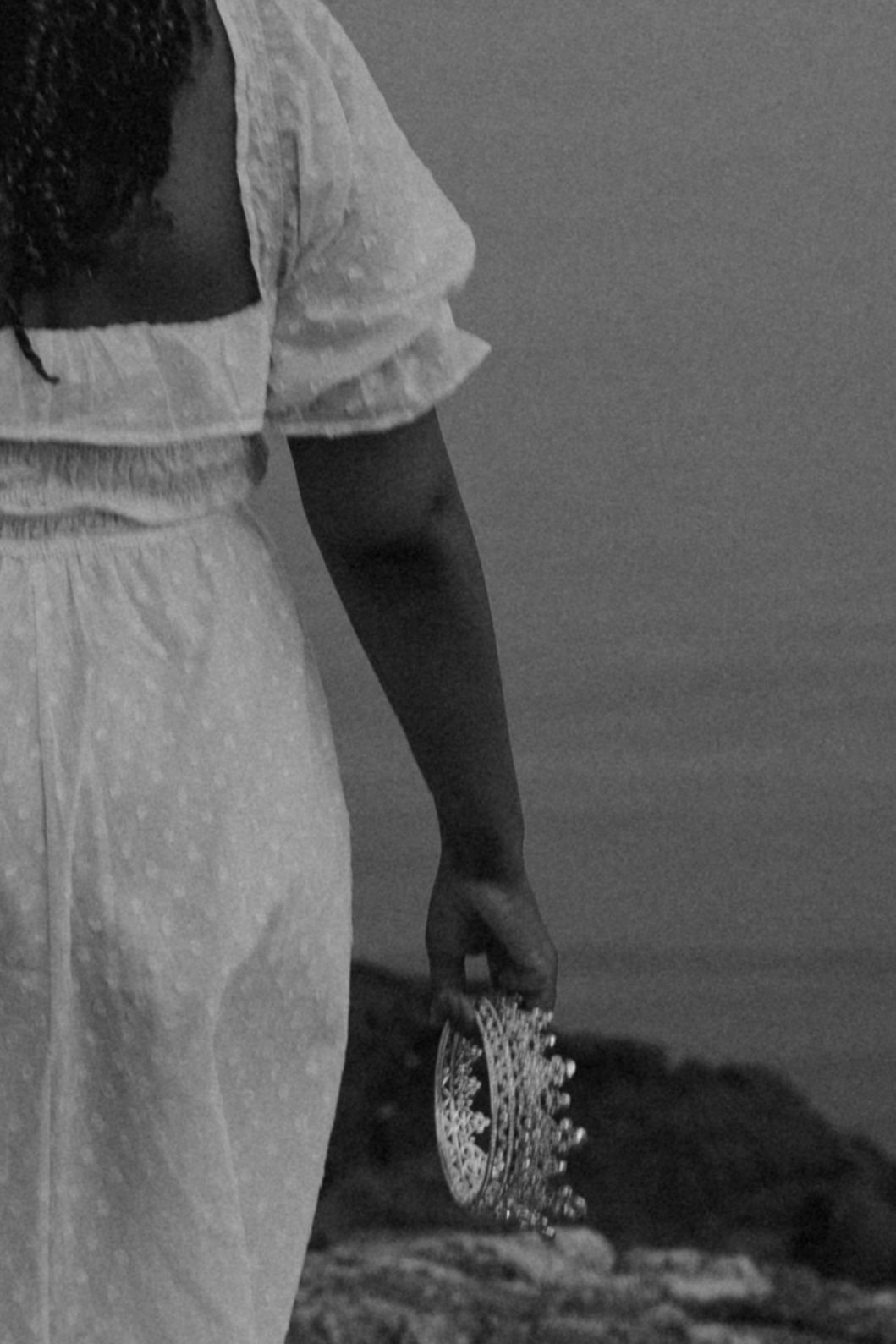 Sequential shots of flowing white dress movement against a dark background.