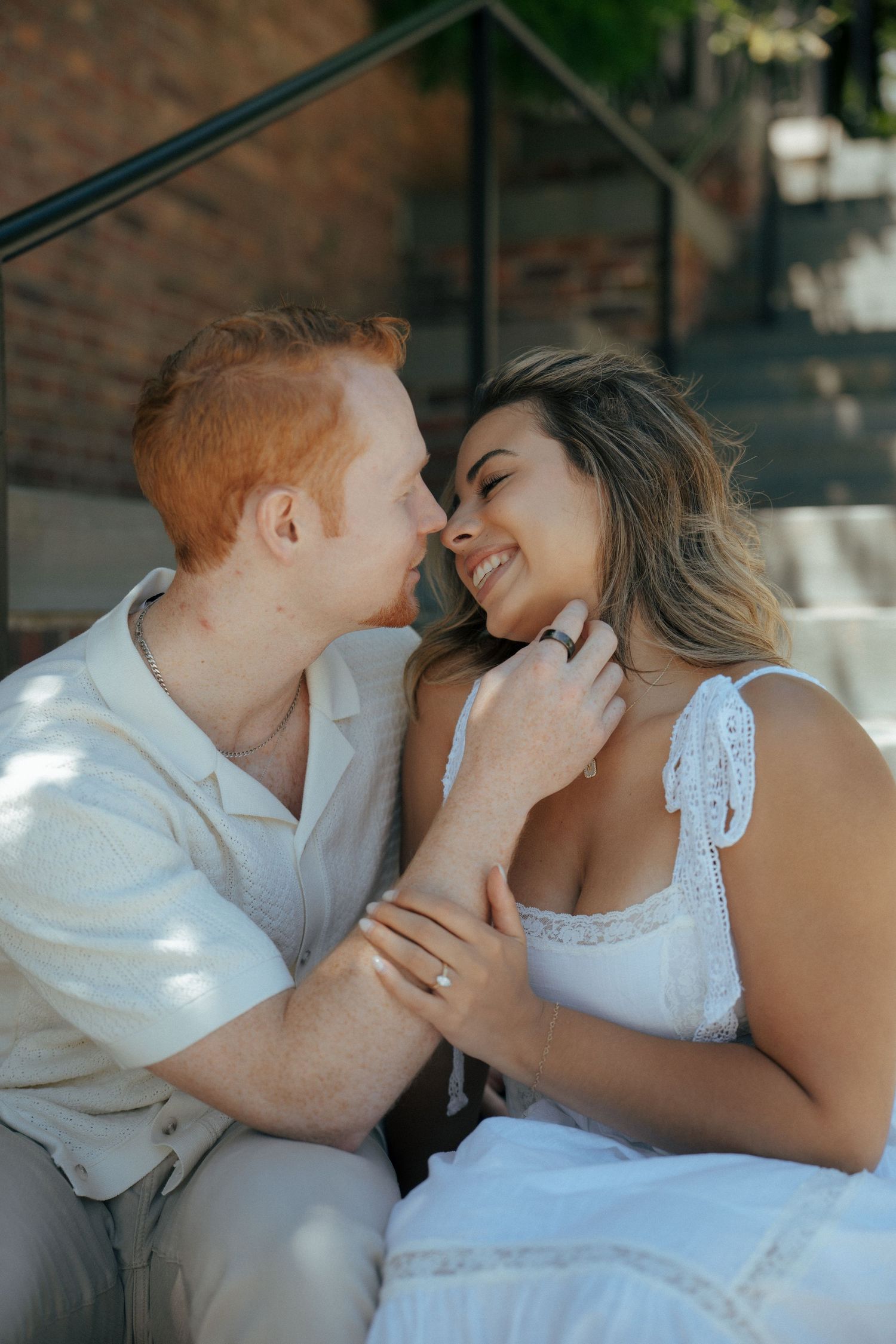 Intimate close-up shots of a couple in white clothing sharing tender moments together.