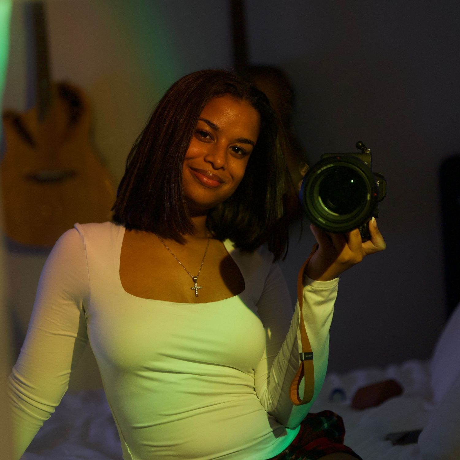 A series of photos showing someone in a white top posing with green lighting effects.