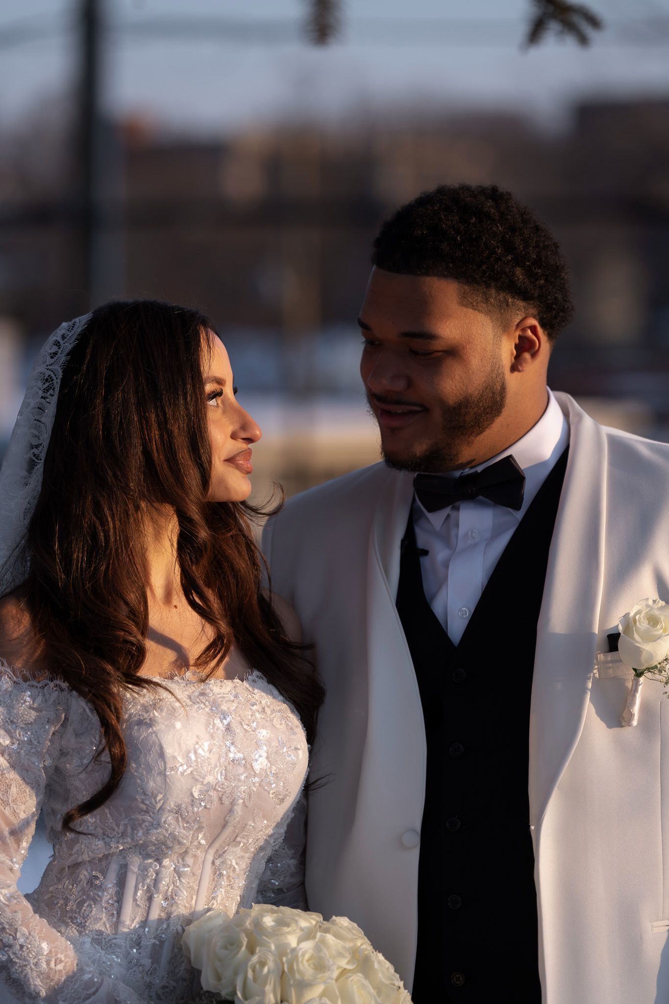 A romantic wedding couple in white attire share intimate moments in a series of candid photos.
