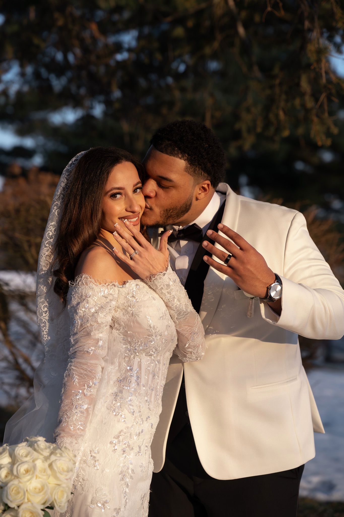 A romantic winter wedding photo series shows tender moments between newlyweds against a snowy backdrop at sunset.