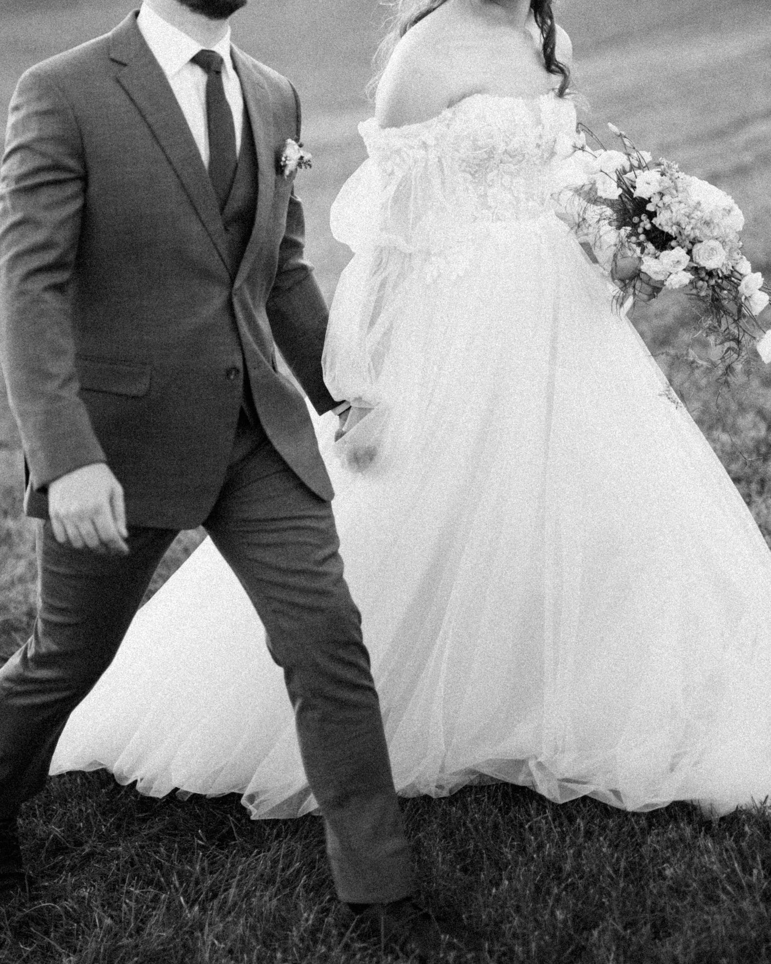Black and white capture of wedding couple's formal attire details.