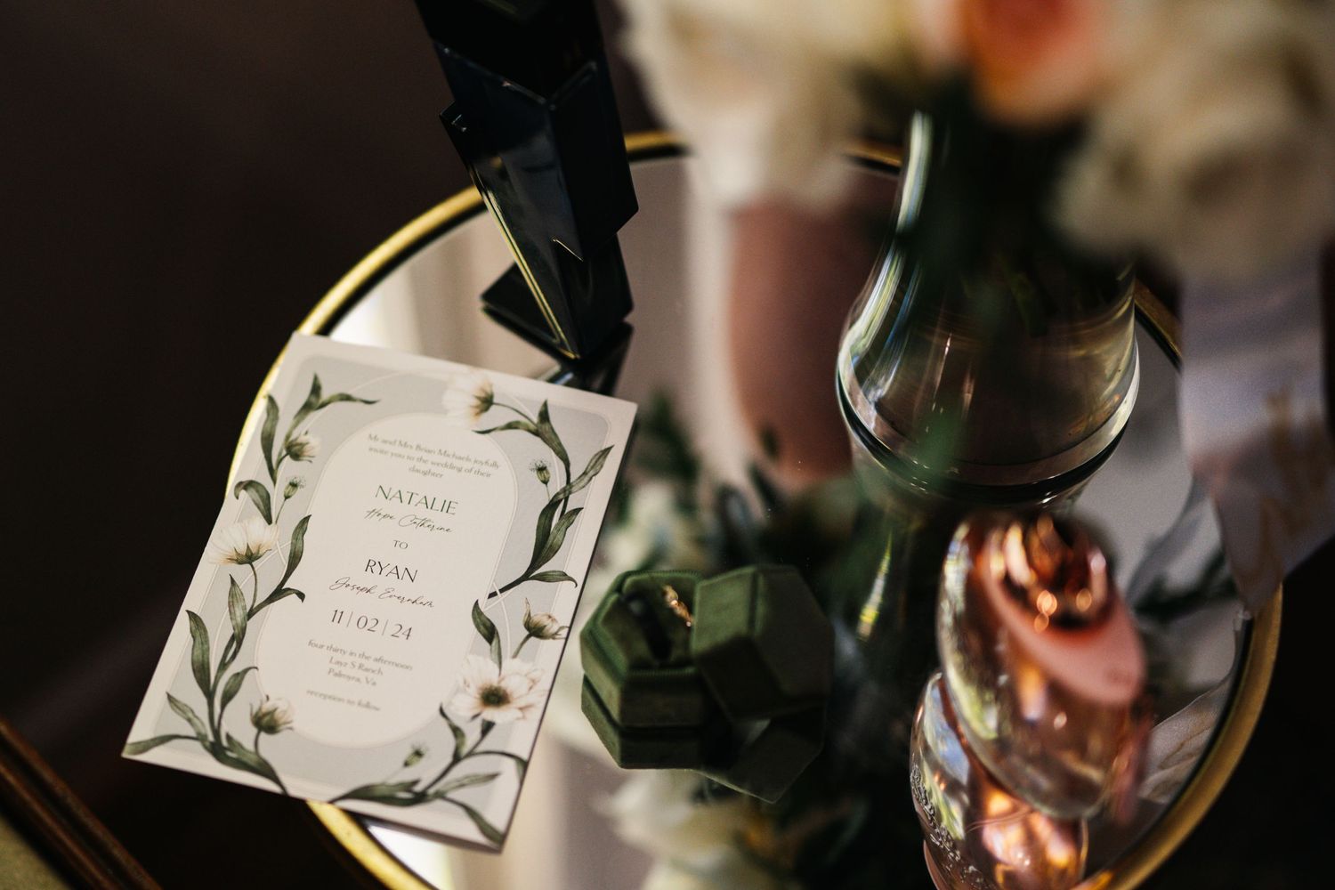 Elegant wedding invitation with floral design and wine bottle detail.