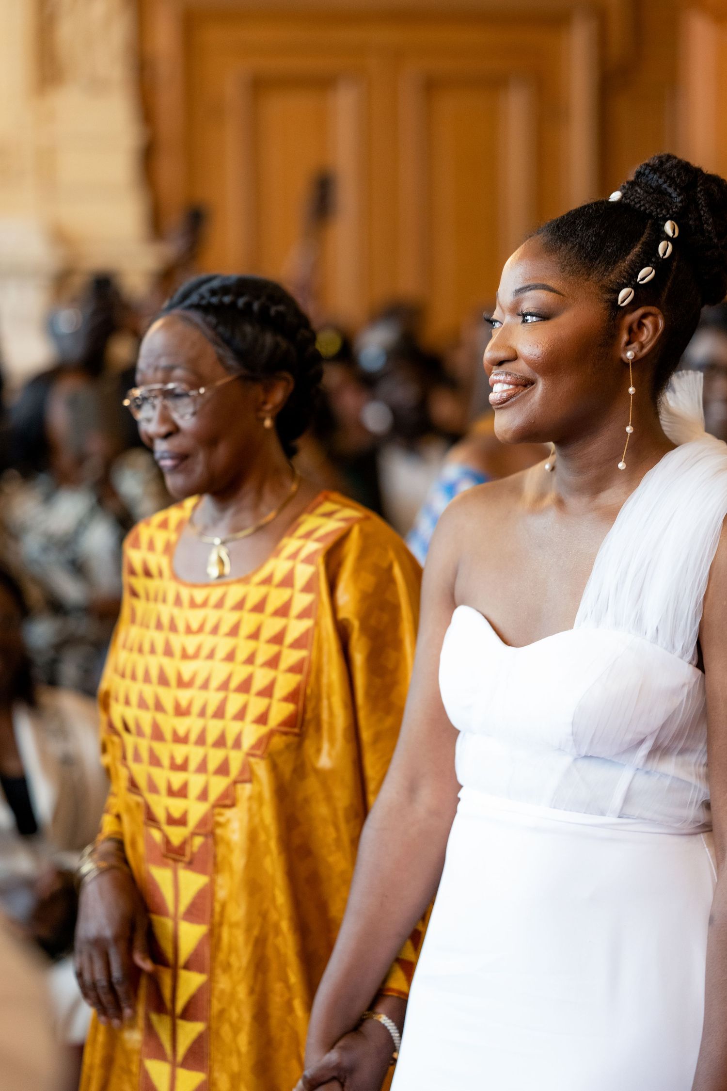 A series of joyful moments captured showing traditional African attire with vibrant yellow patterns and white dresses.
