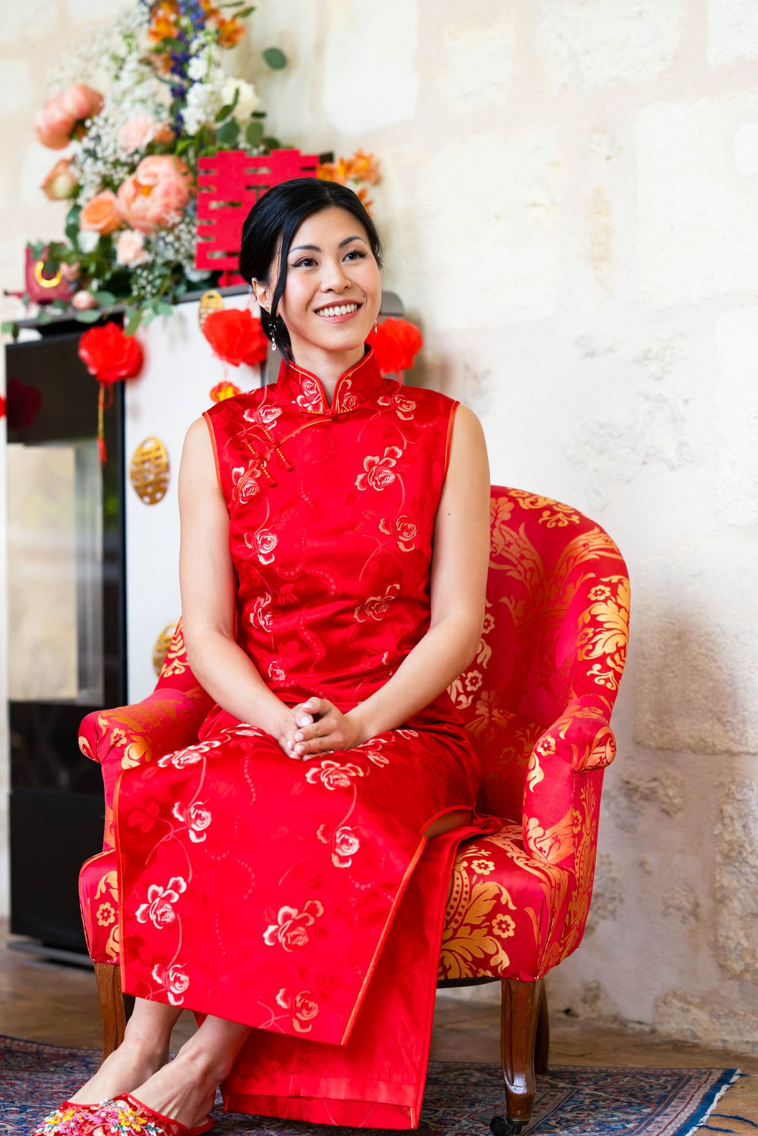Traditional red and gold Chinese dress displayed in an elegant setting.
