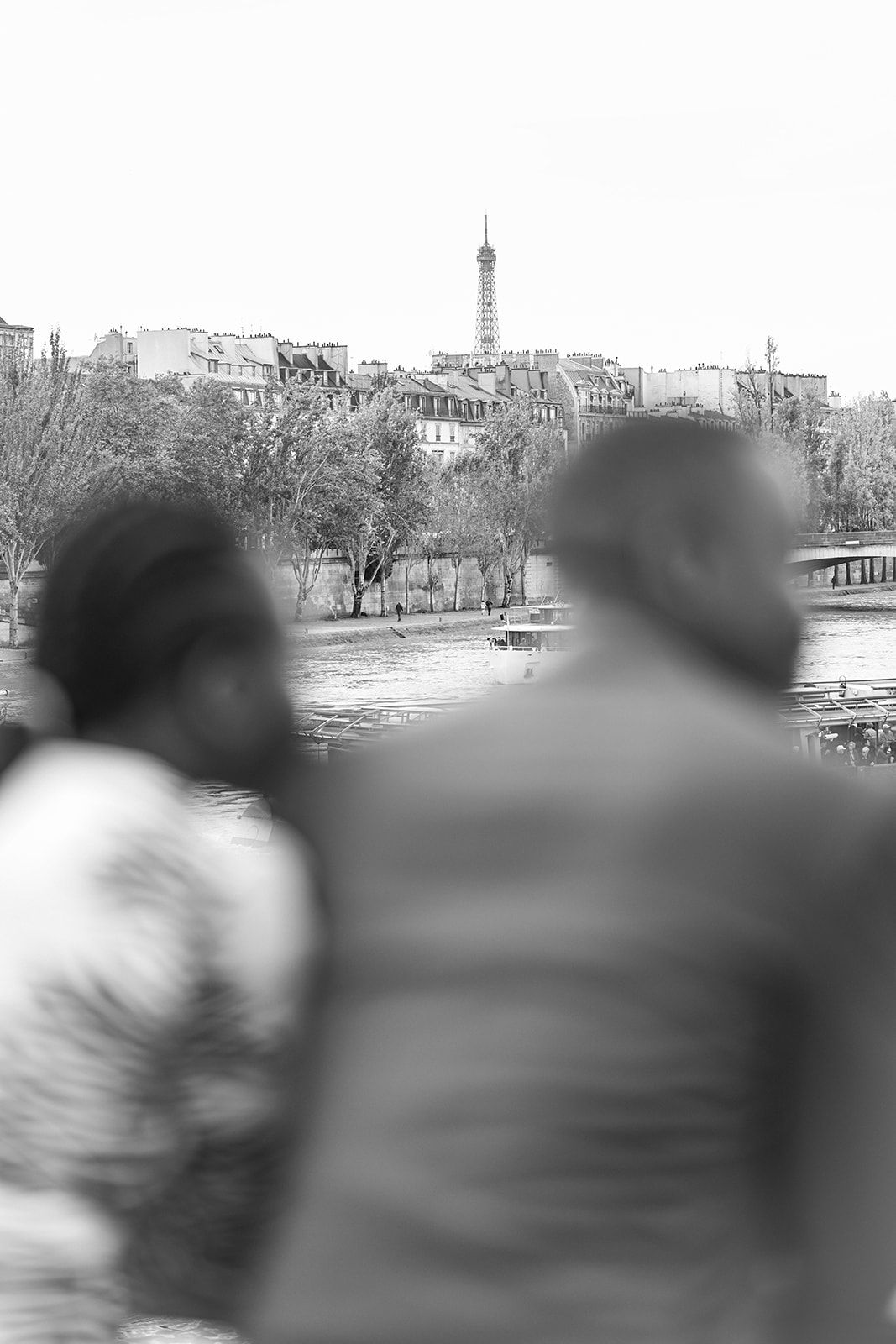 A blurred black and white landscape photo showing city buildings in the distance.