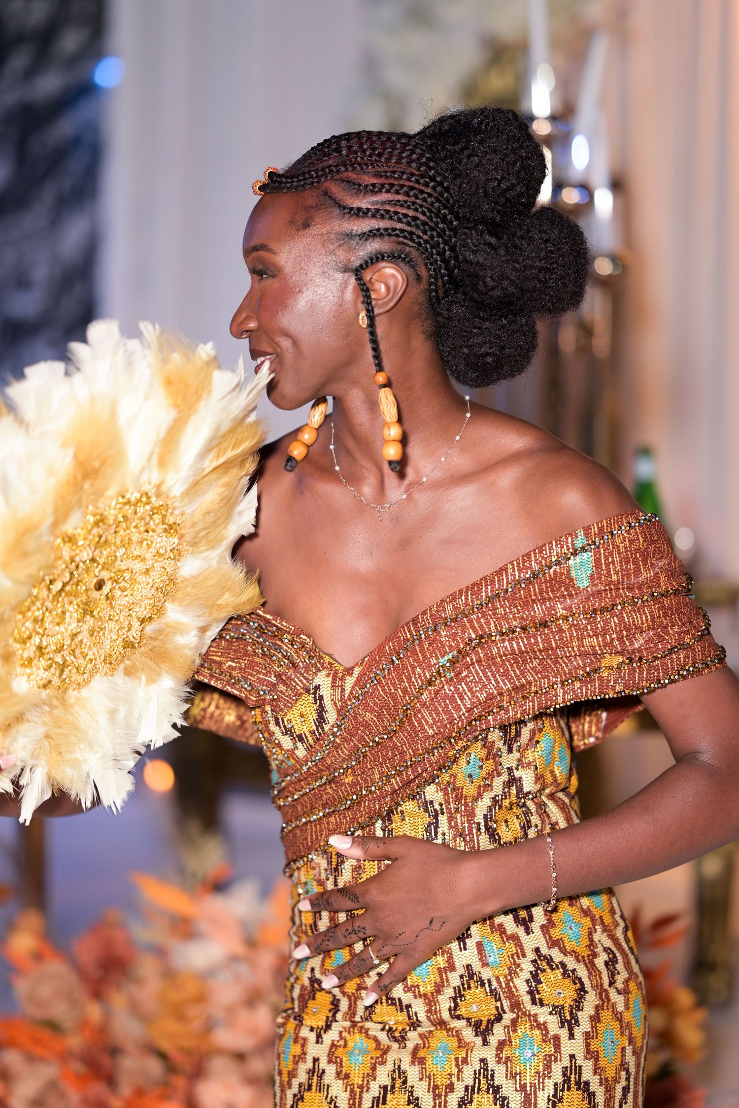 Dancer in golden African print dress performing with elegant movements.