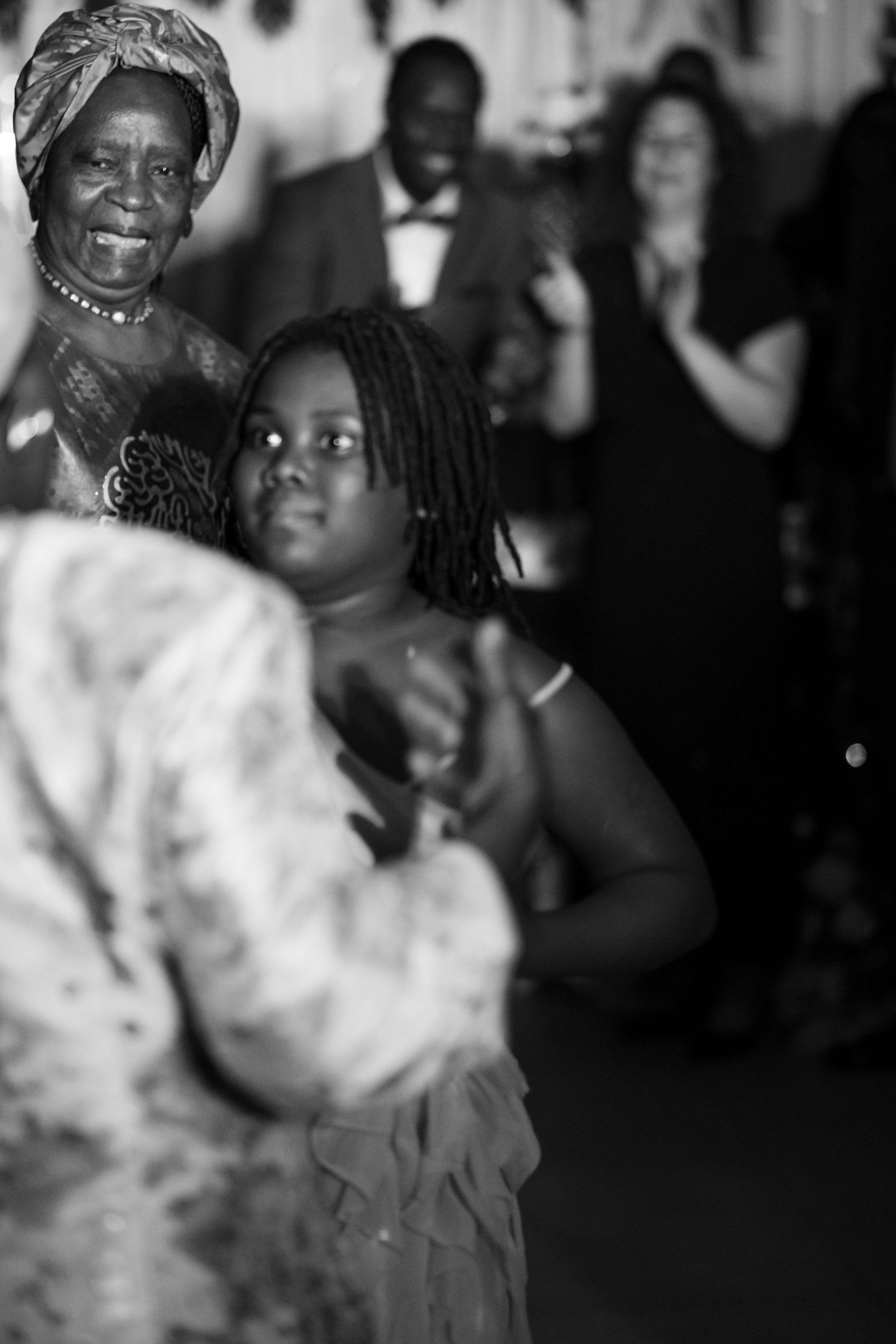 Guests enjoying themselves at formal celebration wearing traditional attire.