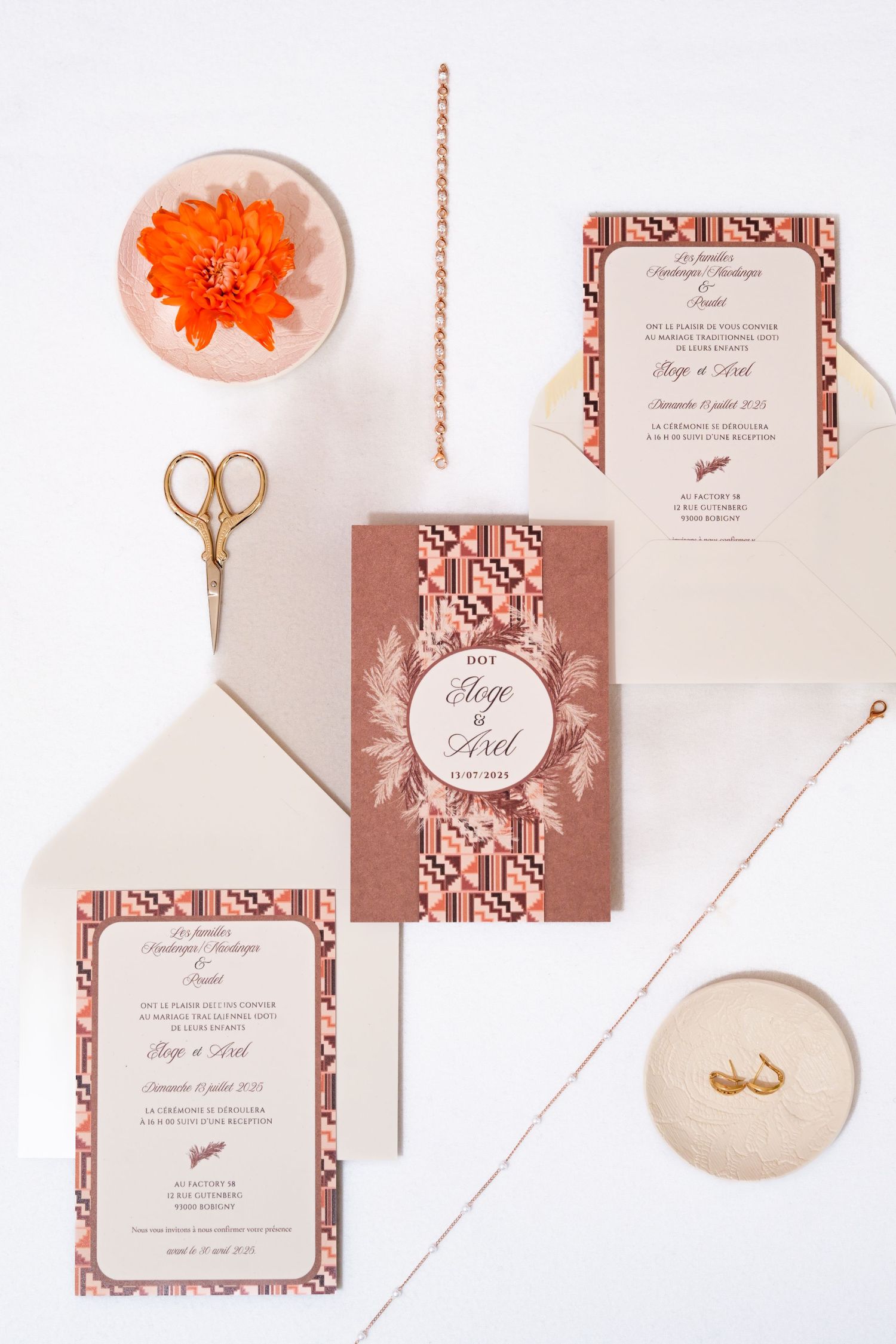 Wedding invitation suite featuring rose gold geometric patterns and coral floral details.