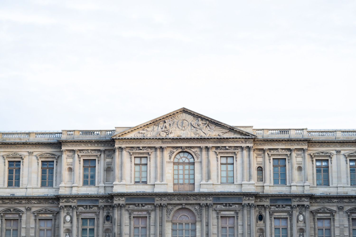 Majestic exterior view of the Louvre Museum displaying its impressive architectural heritage and design.