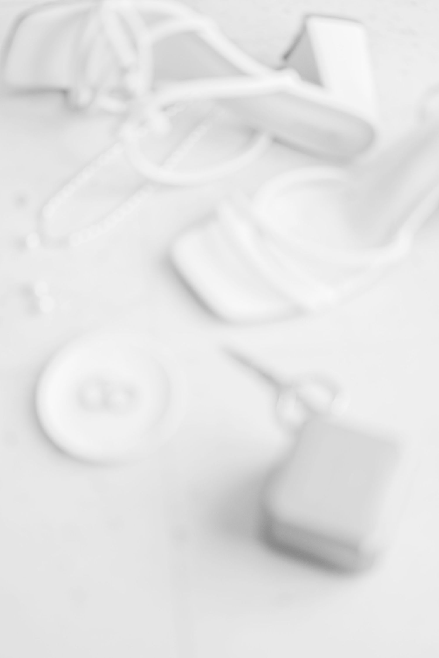 Abstract white textured background with soft flowing fabric-like shapes.