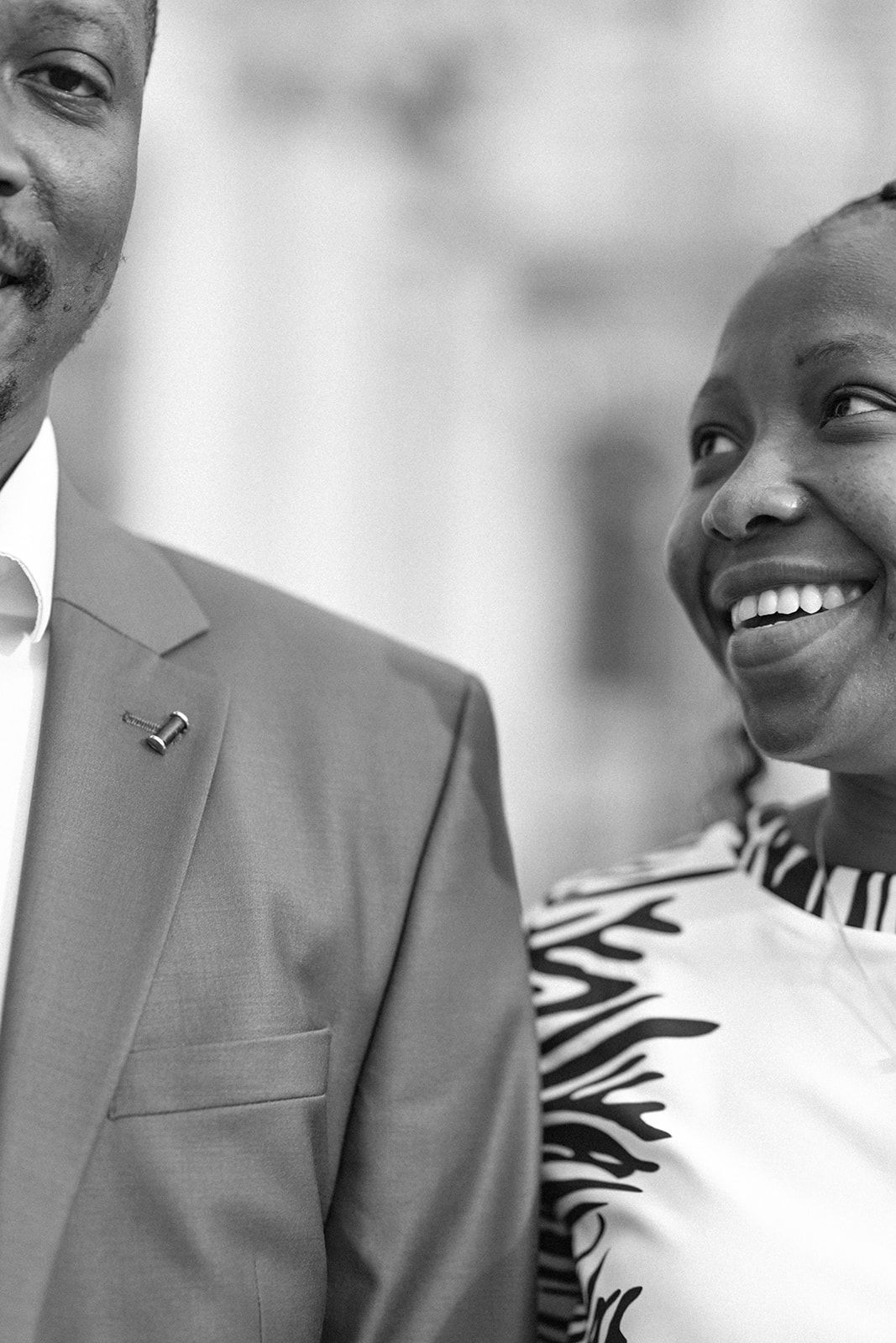 Black and white close-up portrait capturing genuine laughter and joy.