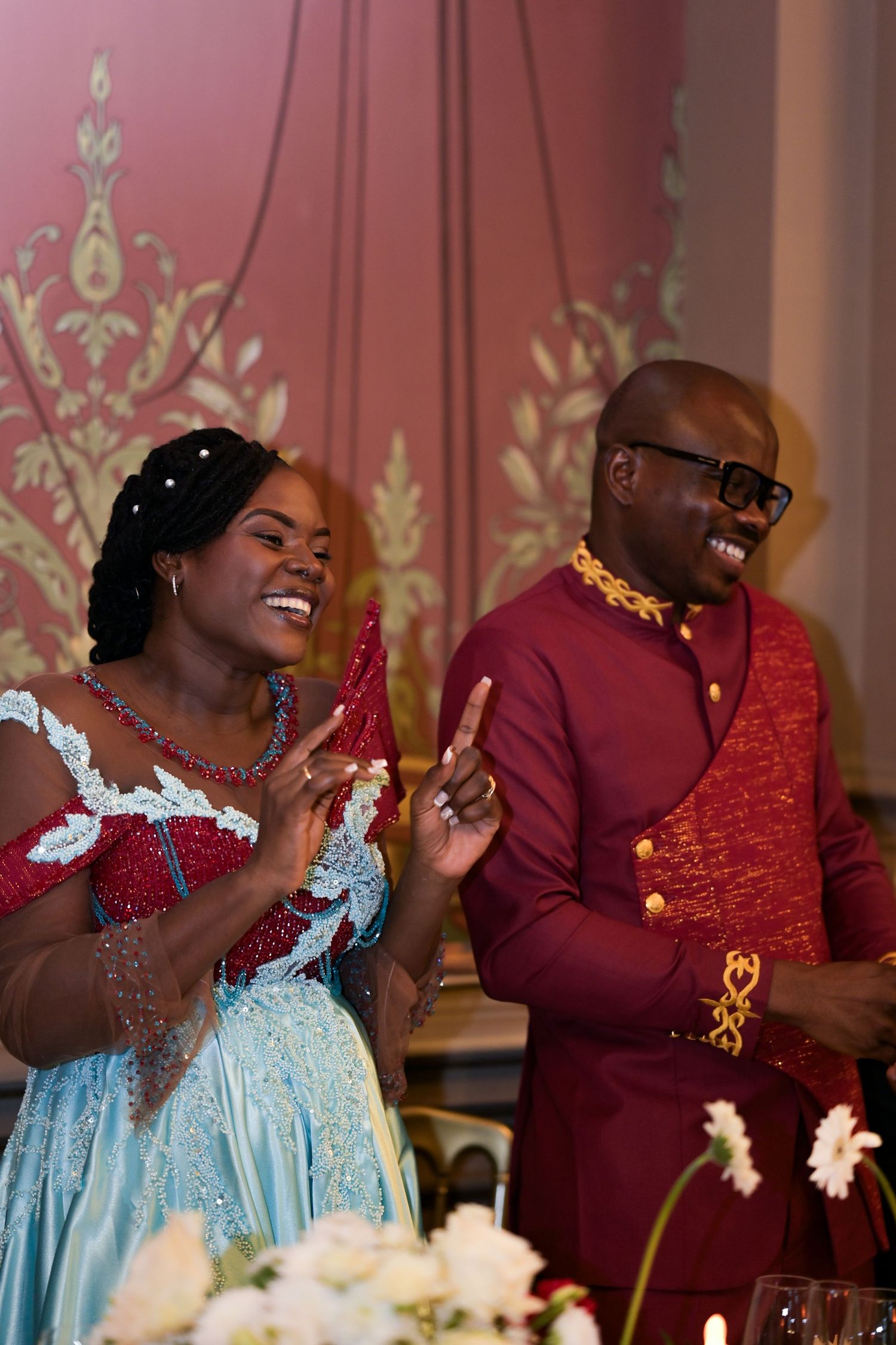 Celebratory moment at wedding reception with guests in formal attire.