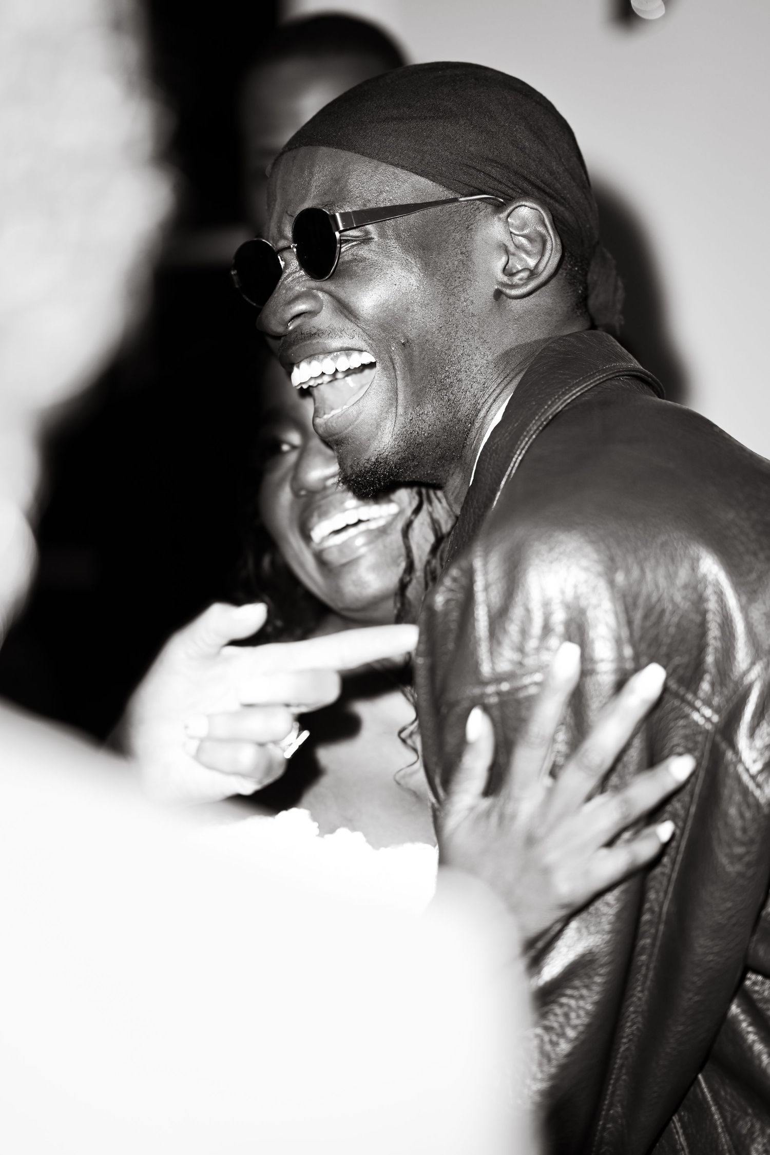 Black and white photograph capturing joyful moment at social gathering.