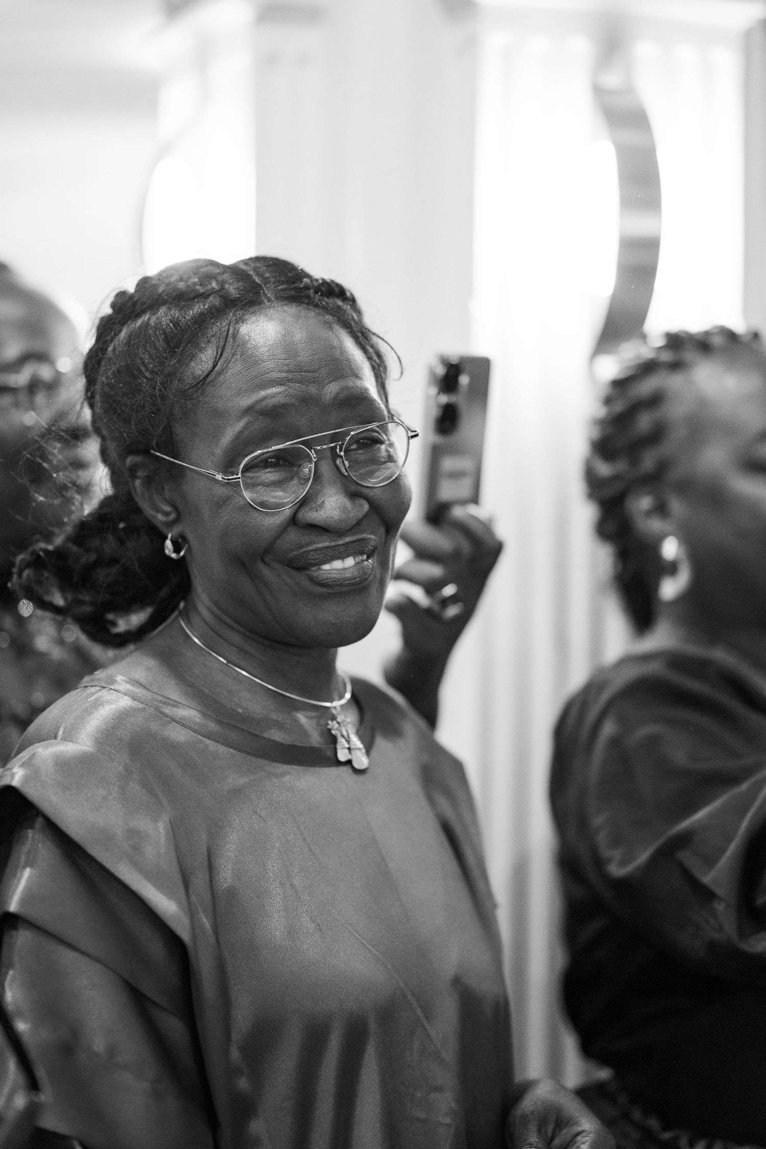 Black and white portrait of women sharing laughter and joy during a celebration.