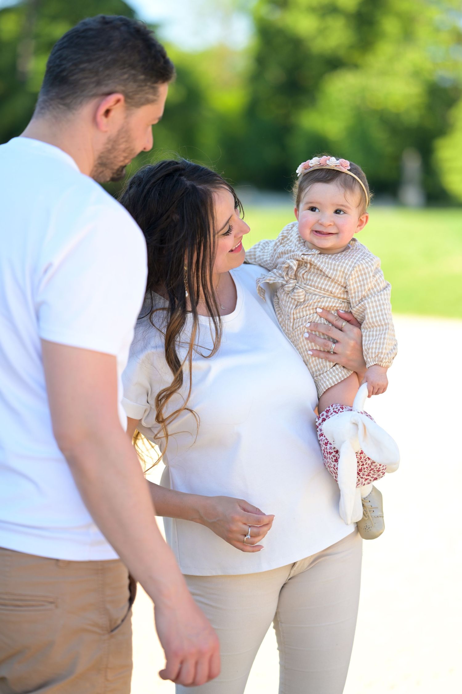 Sweet candid moments of a family playing together outside on a bright summer day.