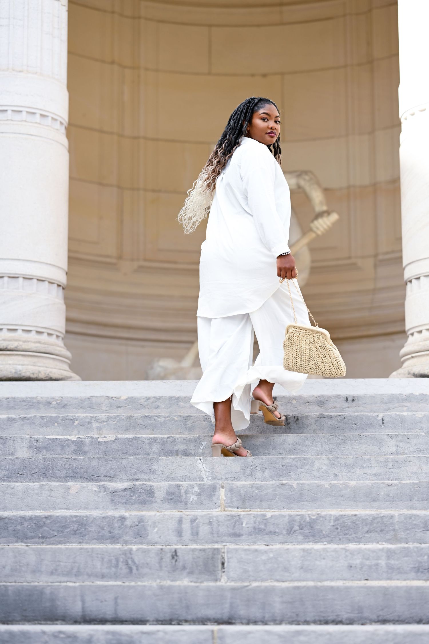 Sequence of elegant poses on grand stone steps with classical columns in background.
