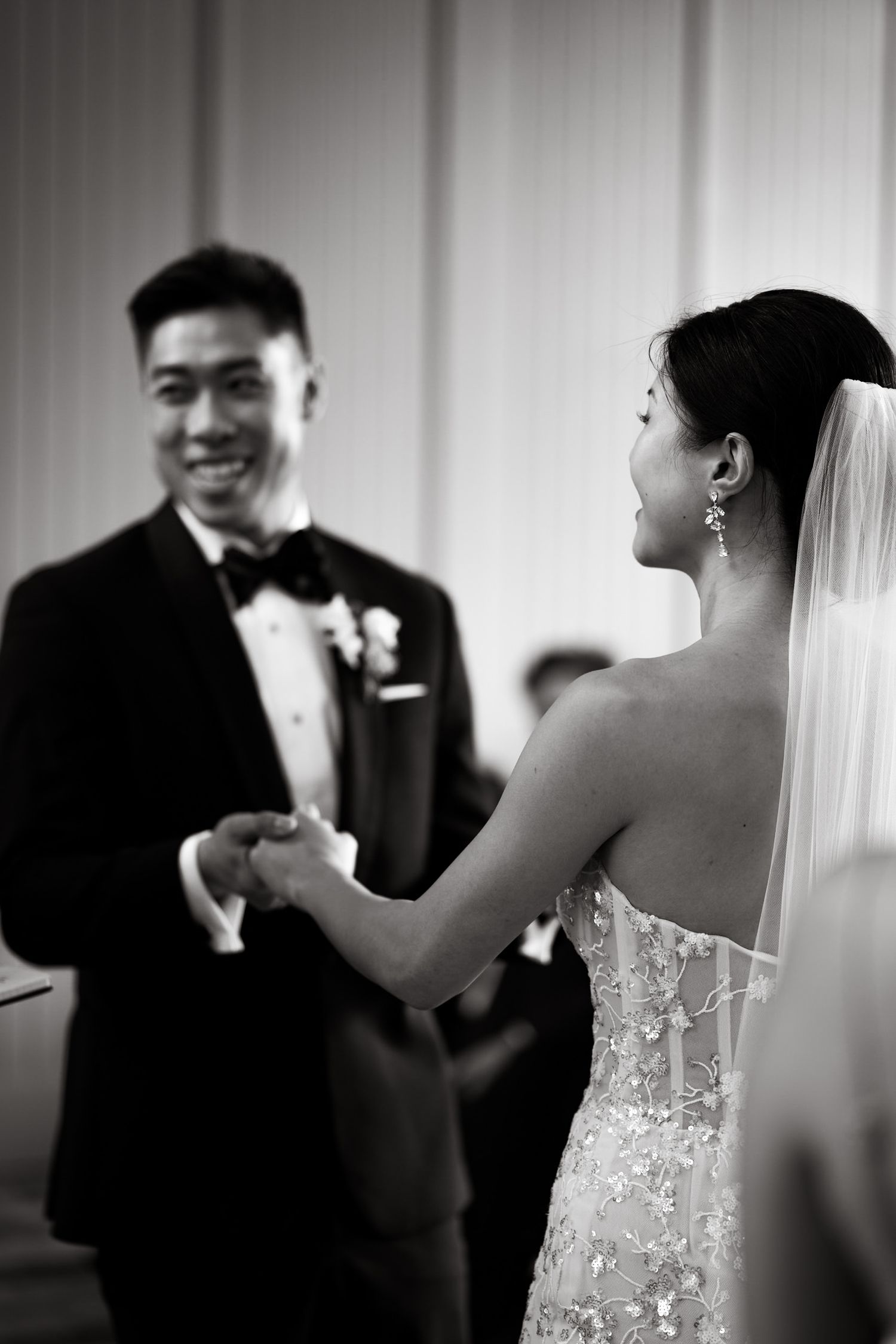 Black and white candid moment during wedding ceremony vows.