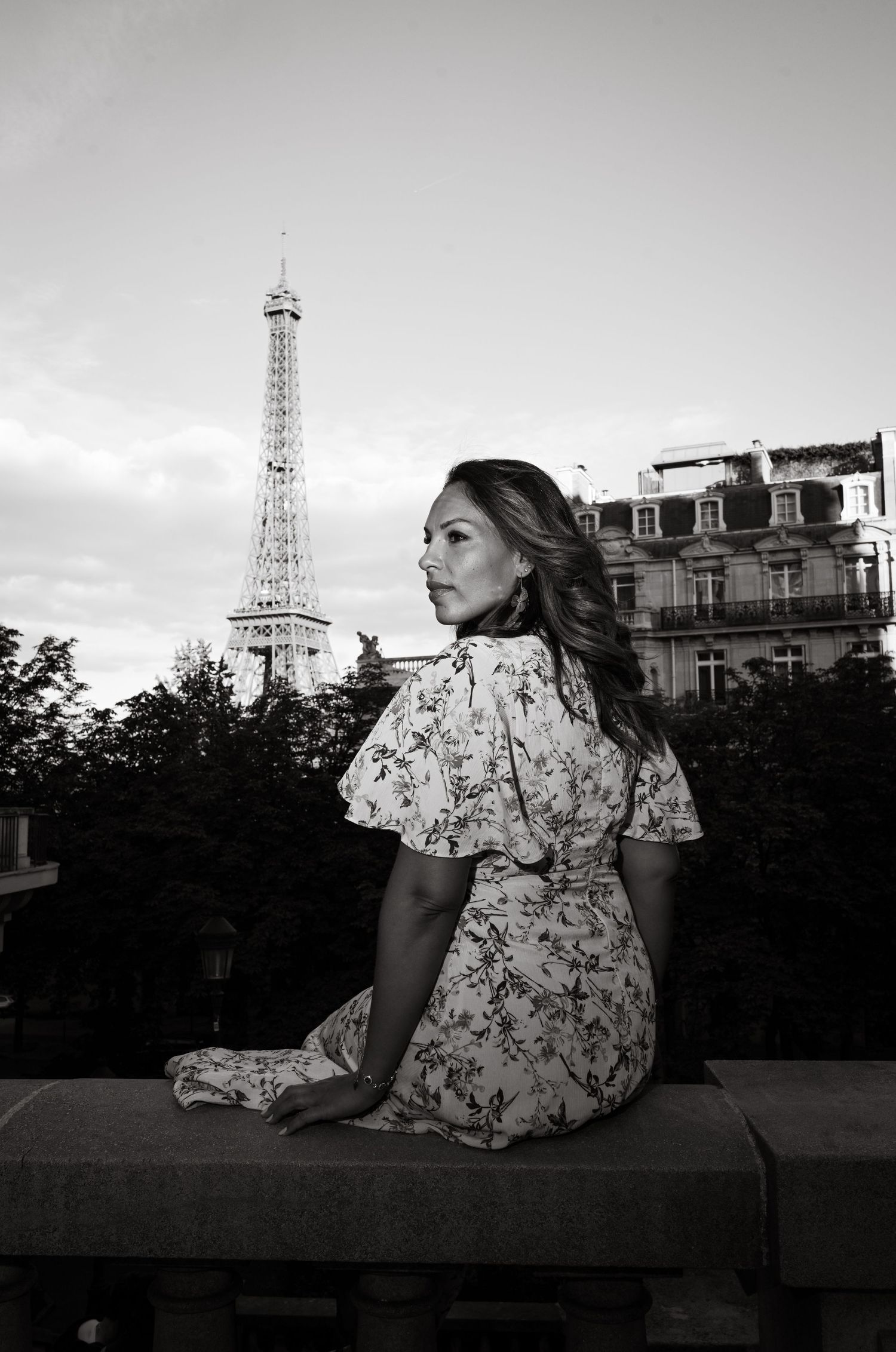 Floral dress silhouette against Paris skyline with Eiffel Tower at dusk.