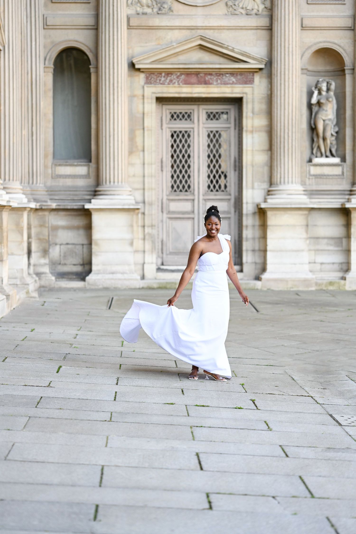 A sequence of playful poses in front of a classical stone building with columns and arches.