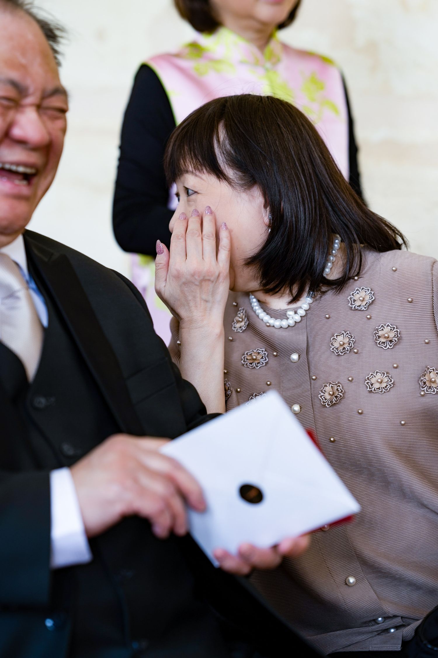 Emotional moment at a wedding ceremony as guests react to a heartfelt moment.