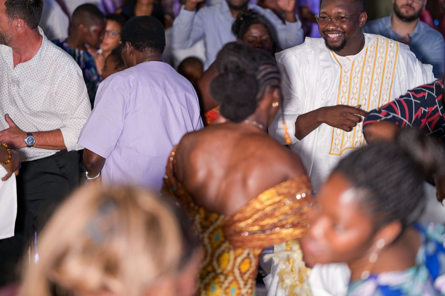 Crowd of people enjoying themselves at an energetic indoor party.