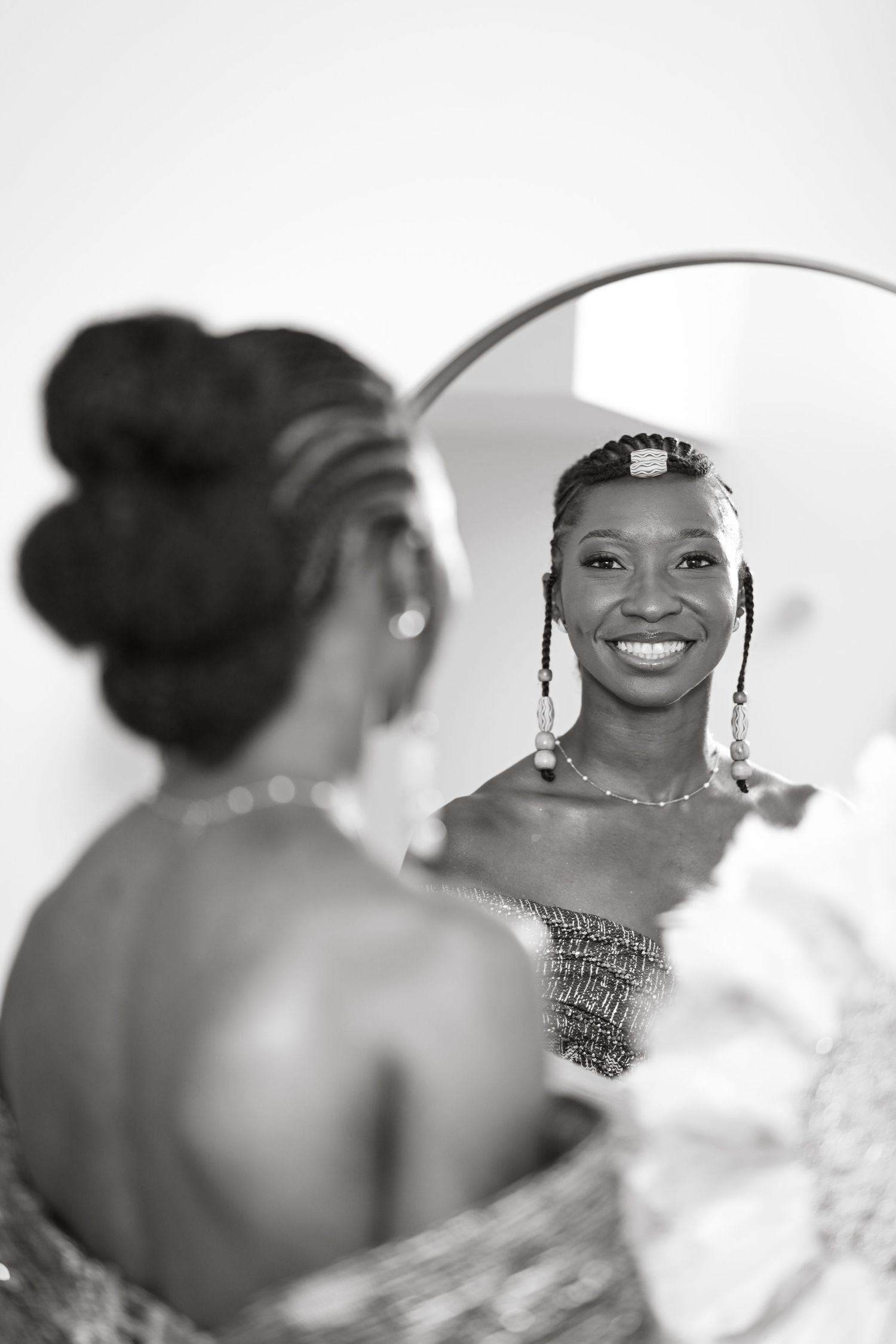 Black and white wedding portraits showing elegant jewelry and updo hairstyles.