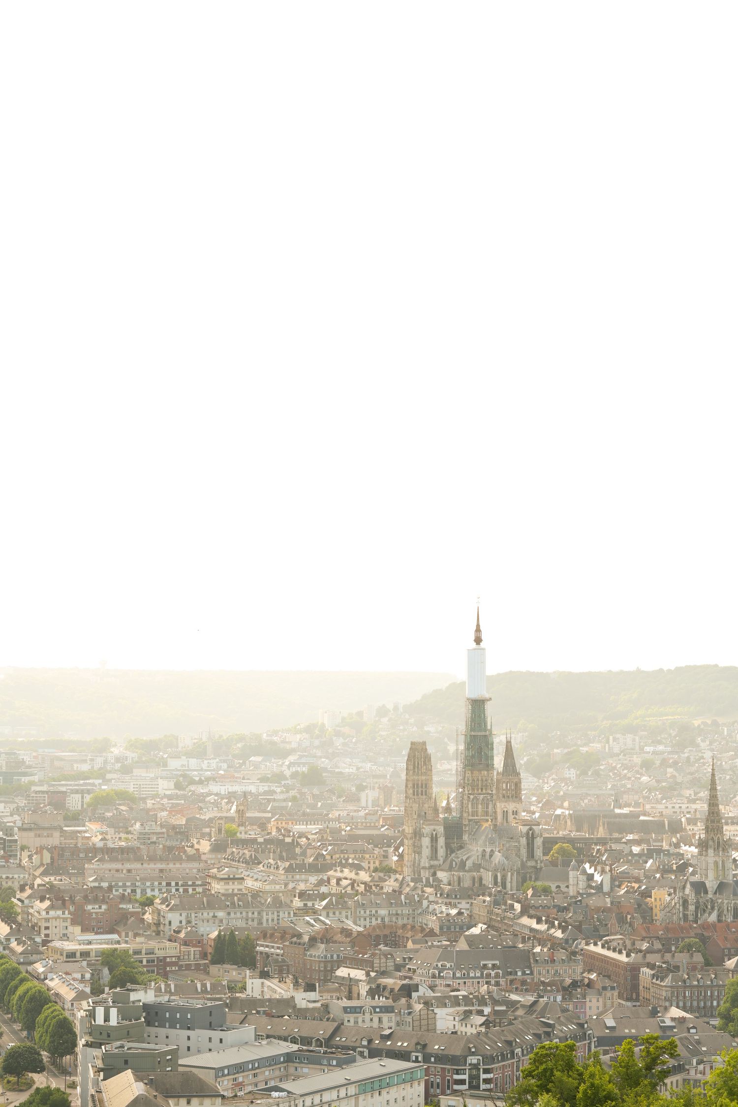 Historic European cityscape with cathedral spires and traditional architecture visible in the distance.