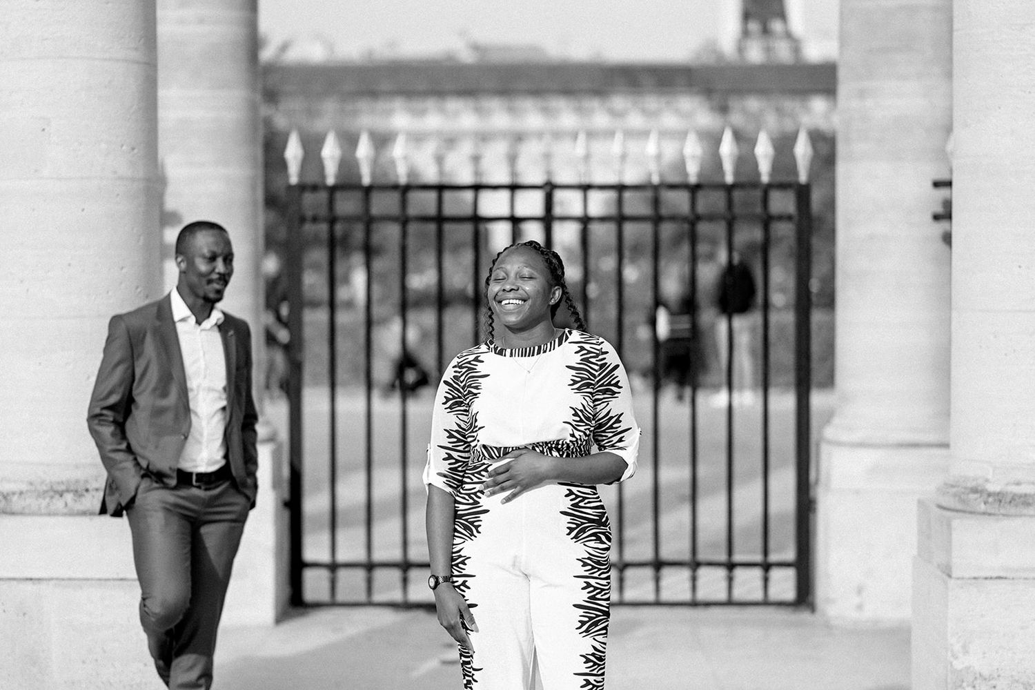 Black and white portrait of a couple sharing joyful moments during their photoshoot.
