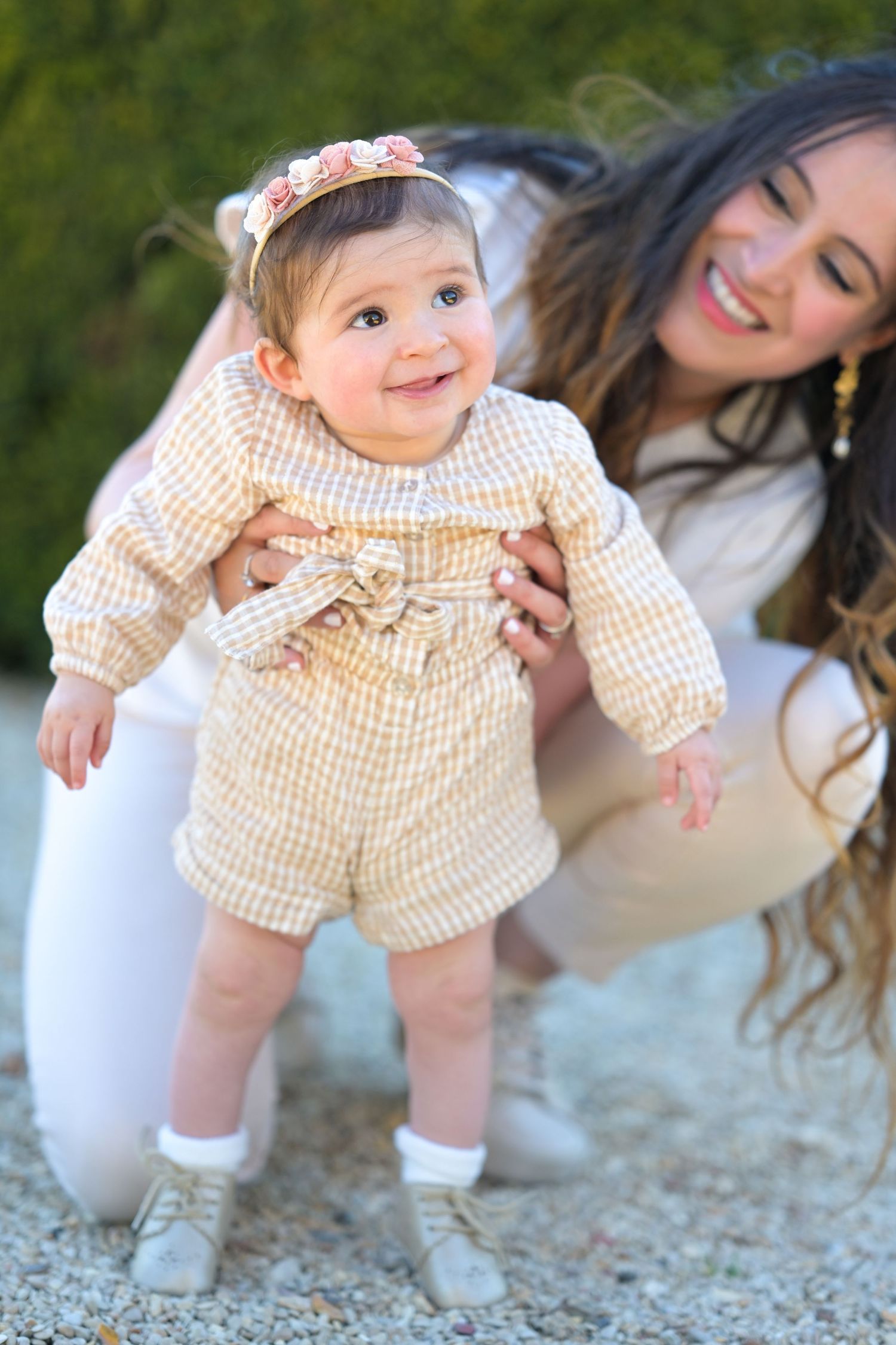Candid outdoor family photos showing playful moments on a gravel path.