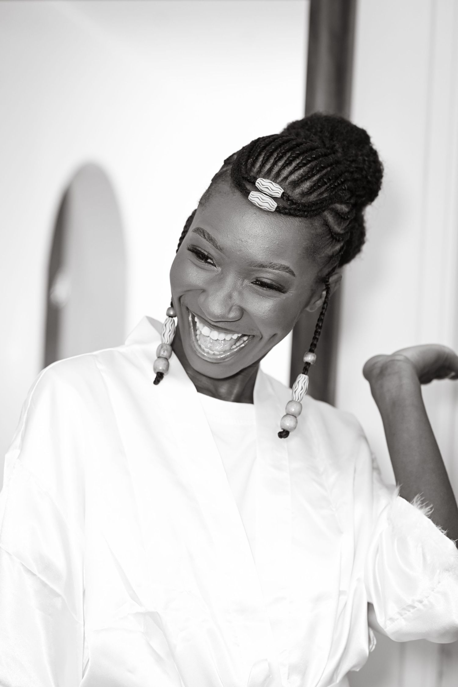 Portrait series showing joyful expressions in white attire against light background.