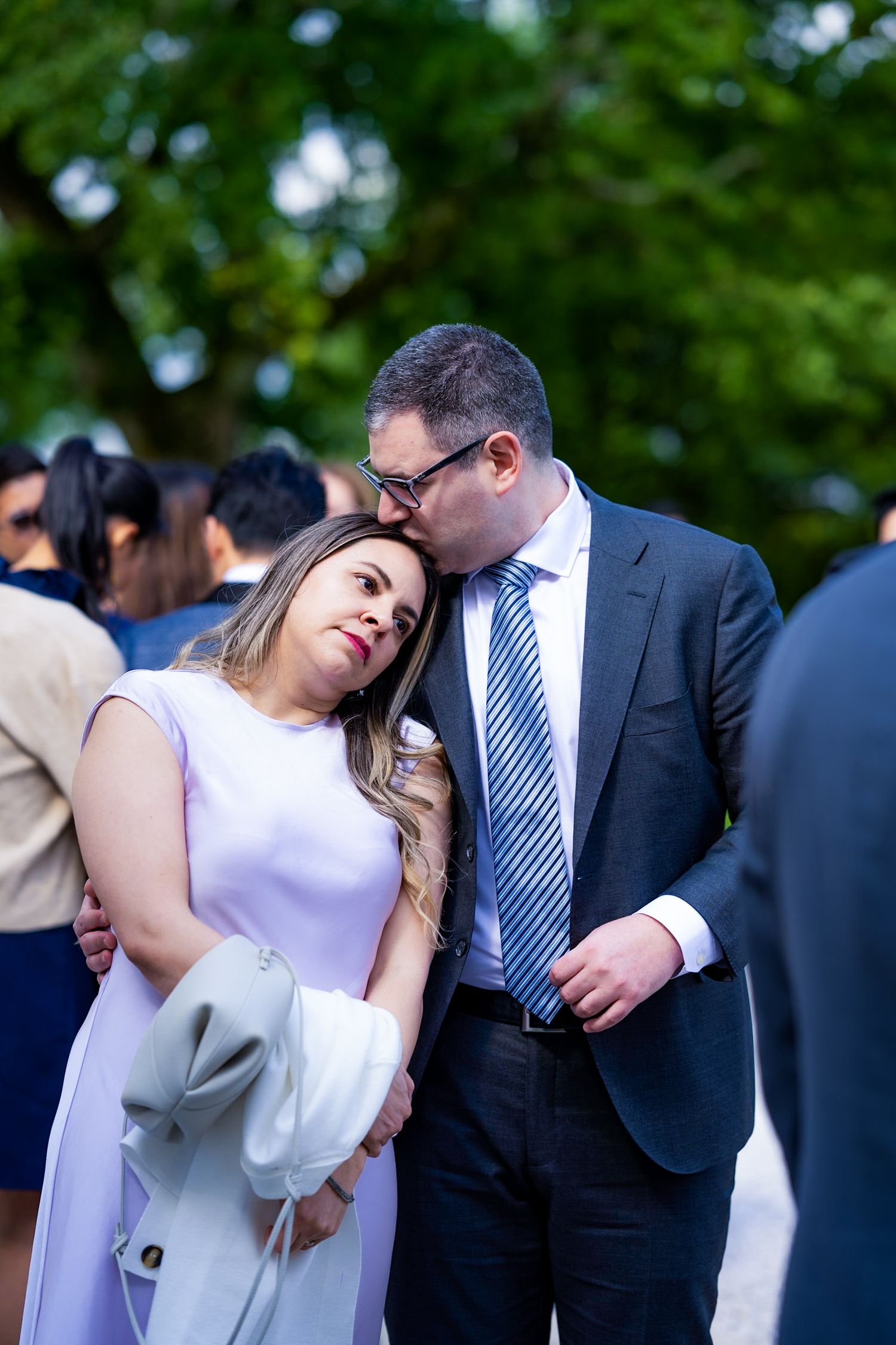 Couple sharing intimate moment at outdoor gathering.