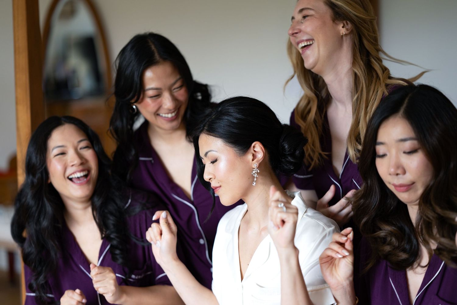 Group enjoying a candid moment during wedding preparations.