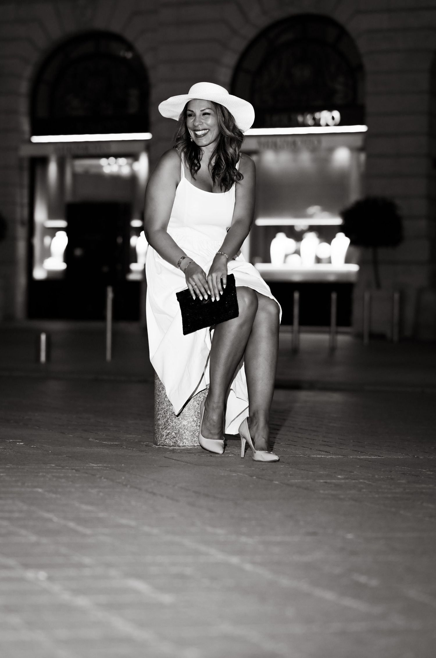 Candid black and white shot showing joyful moment in evening wear.