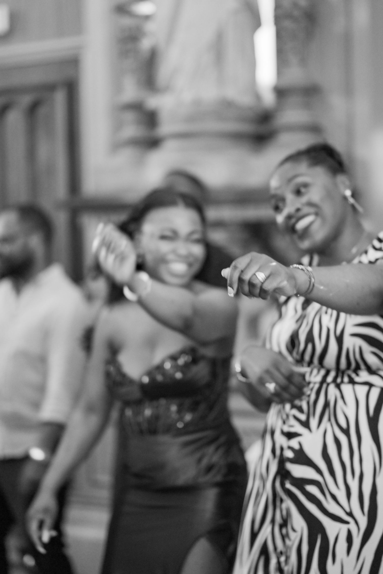 Enthusiastic dancers in black and white zebra print moving to the music.