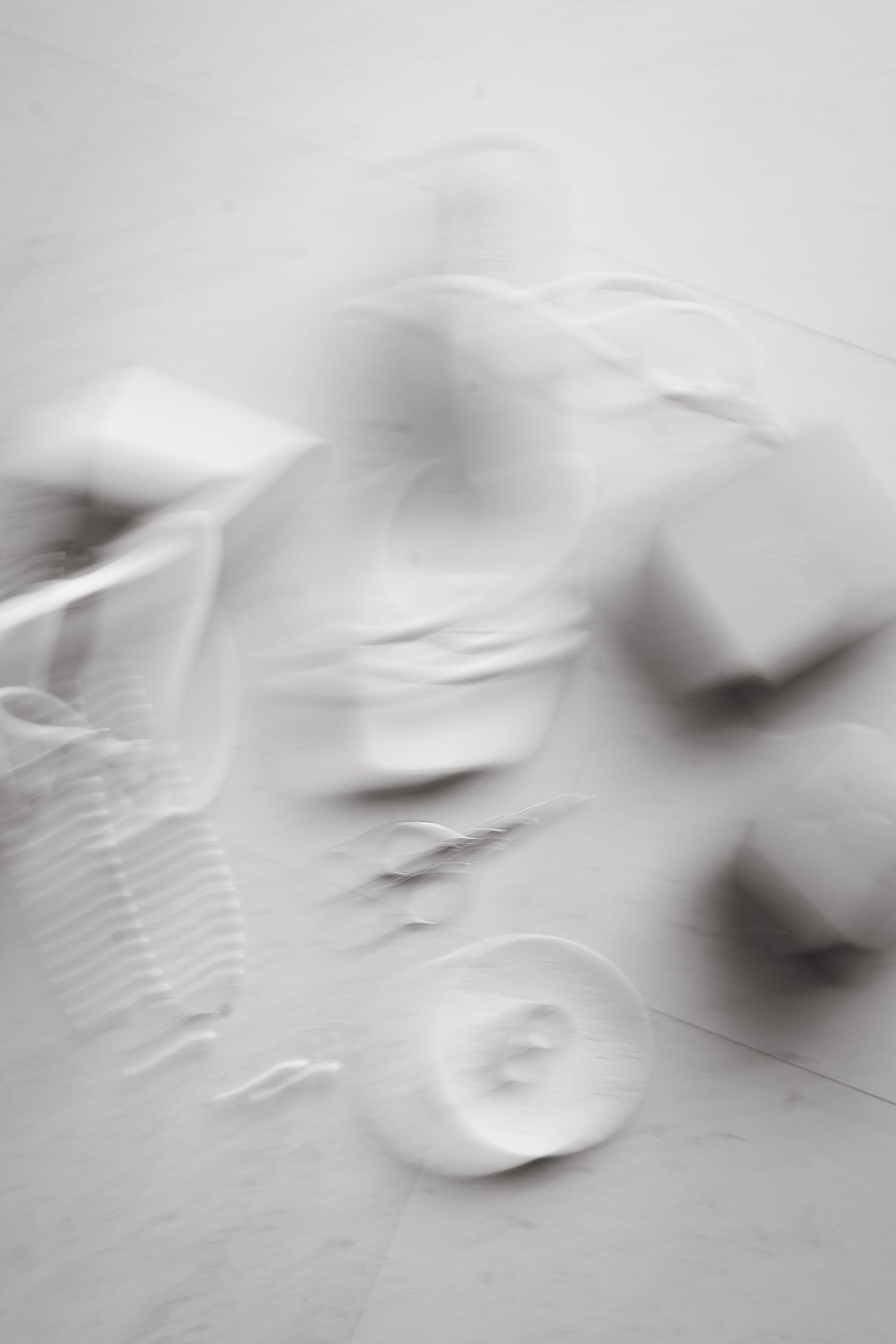 Abstract black and white blurred motion sequence showing gradual movement across multiple frames.