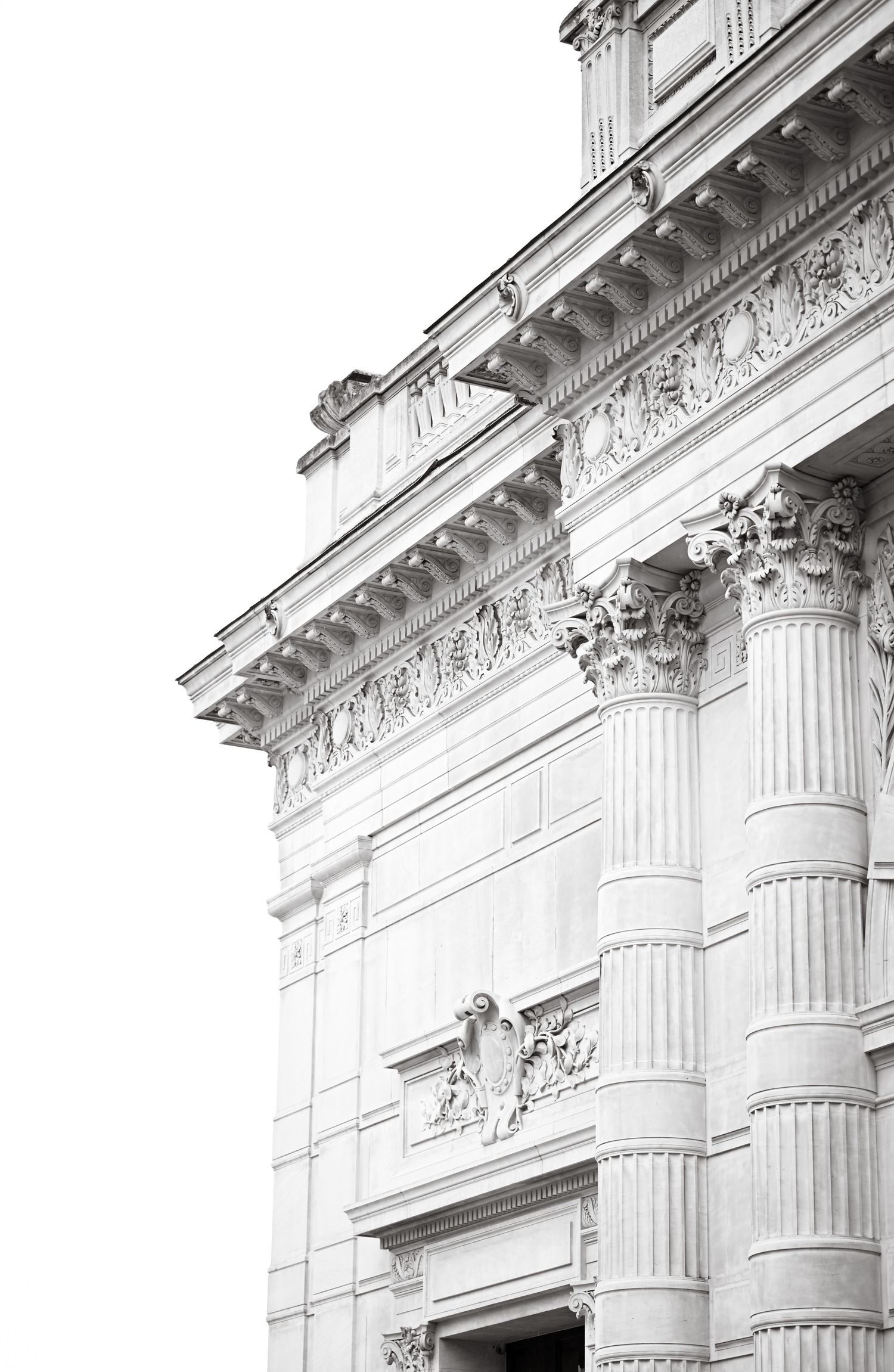 Classical architecture detail showing ornate Corinthian columns and decorative moldings in white stone.