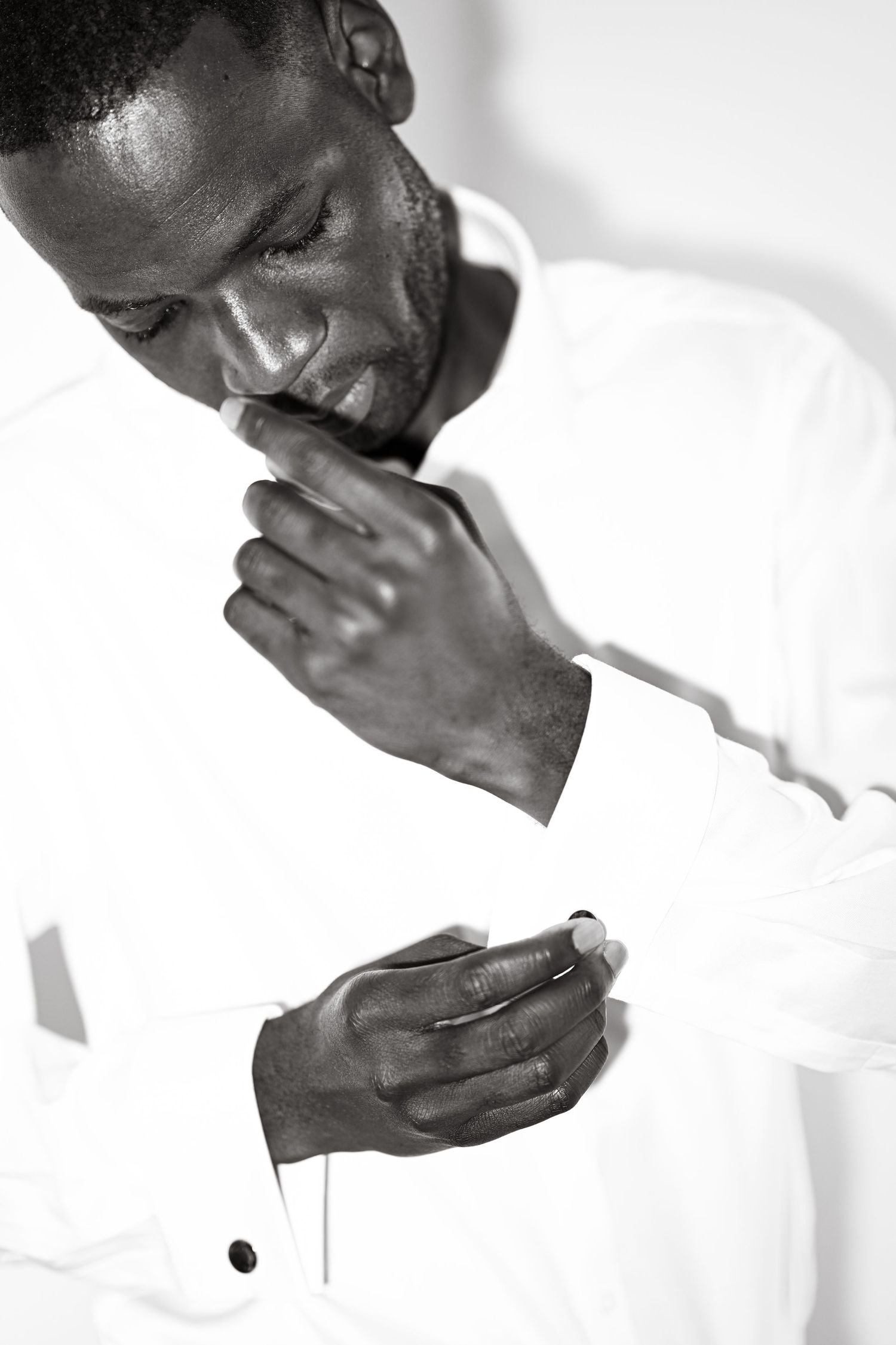 Black and white image of hands covering face in emotional moment.