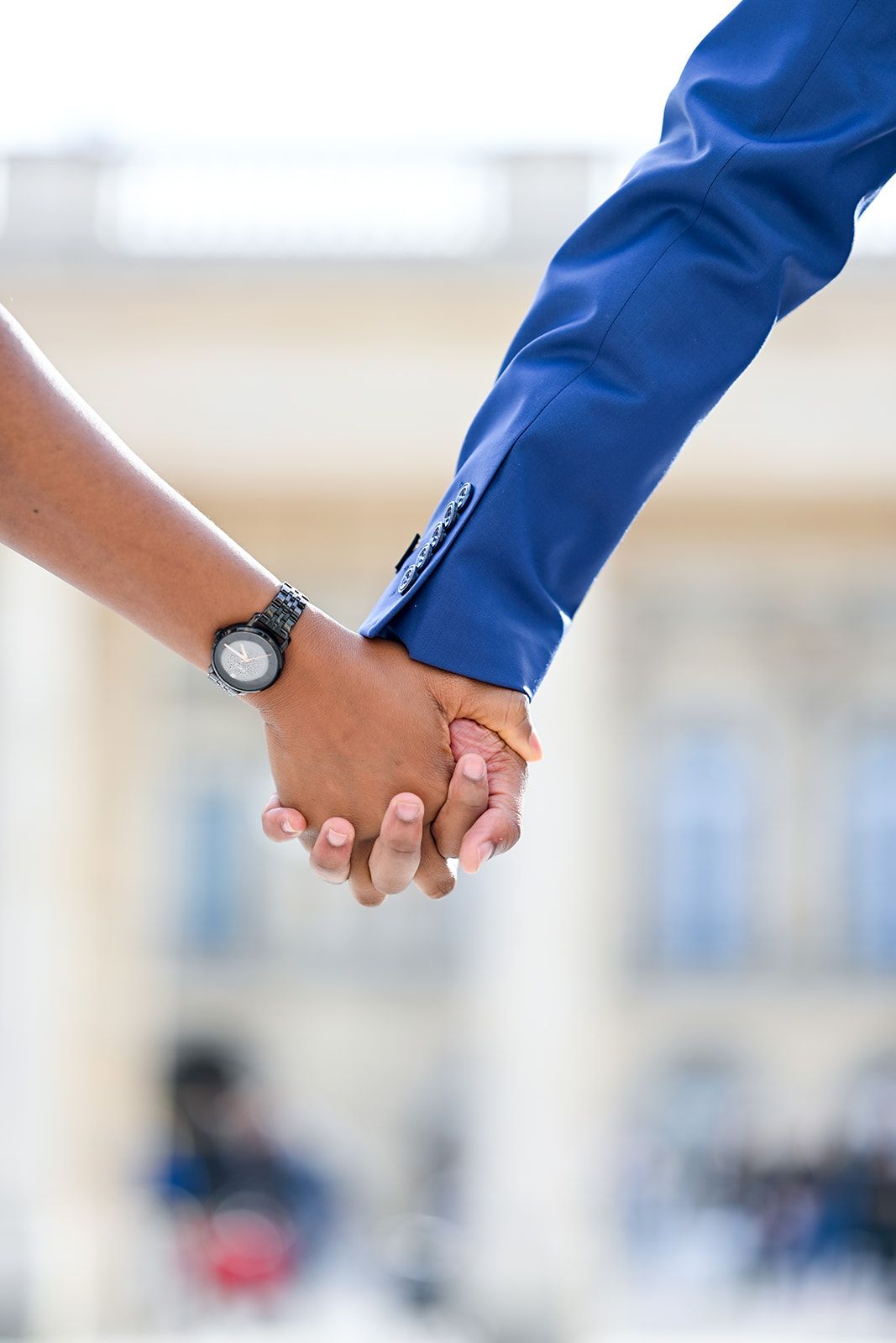 Close-up of two hands clasped together showing intimacy and connection.