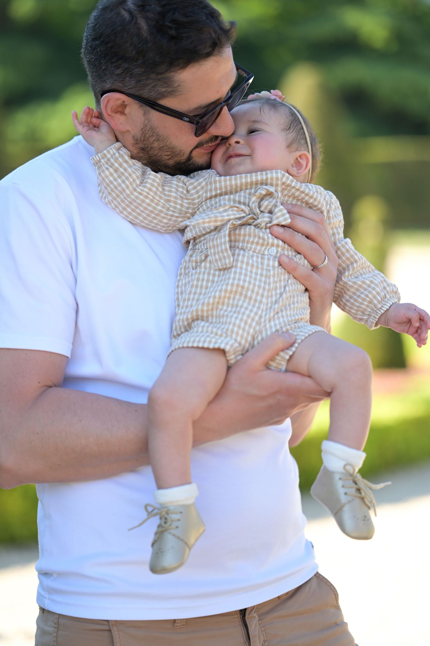 Loving embrace between parent and child in white summer attire.