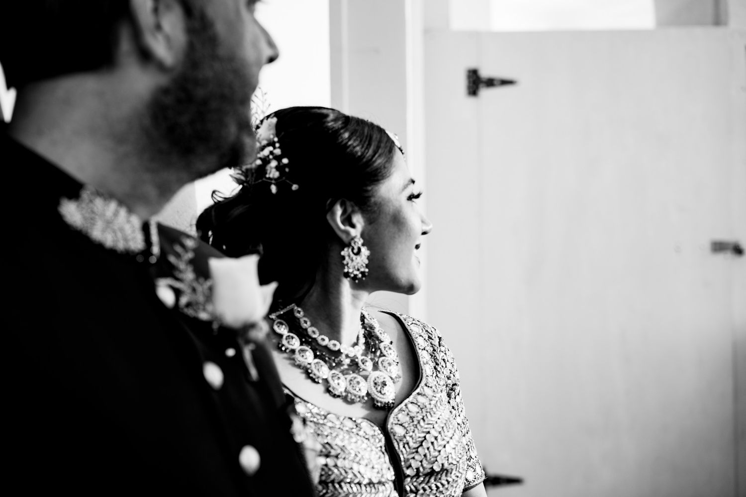 Black and white portrait shots capturing intimate moments during a traditional wedding ceremony.
