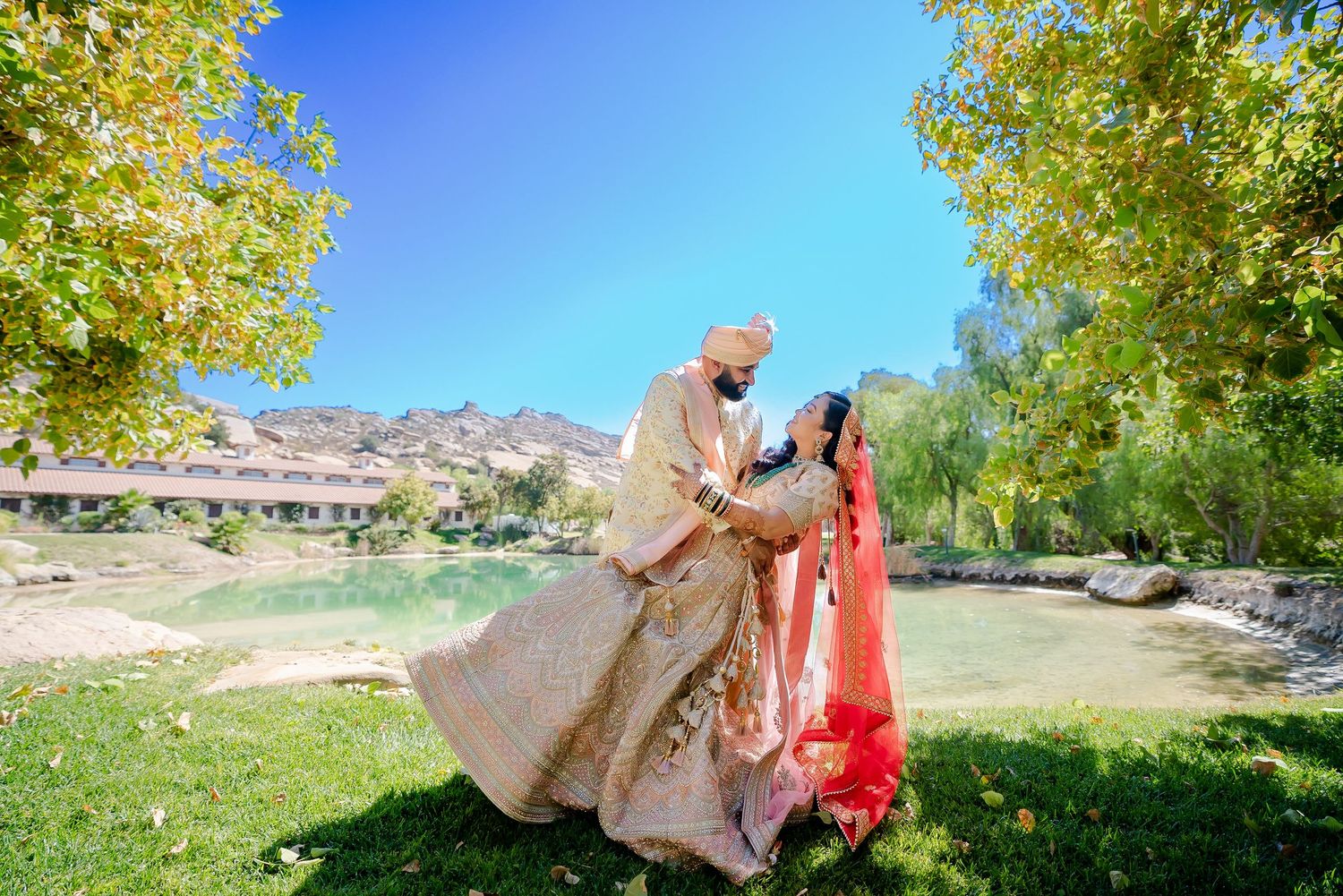 A scenic outdoor photo session in a natural park setting with autumn foliage and mountain views in the background.