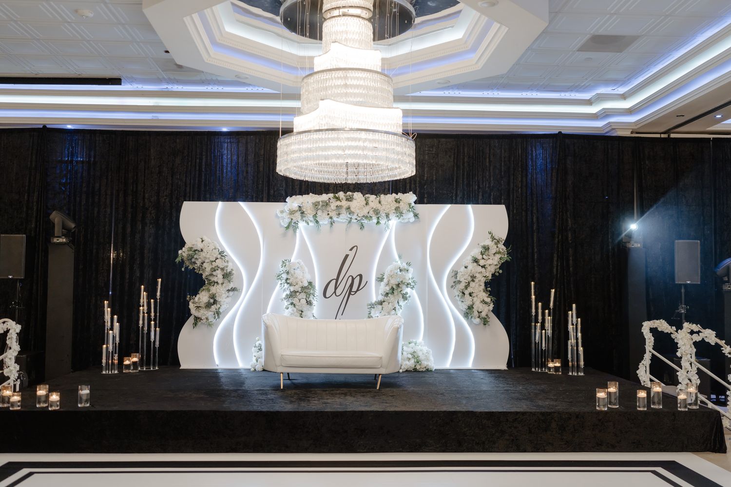 Modern wedding venue interior with illuminated ceiling design and contemporary white lighting fixtures.