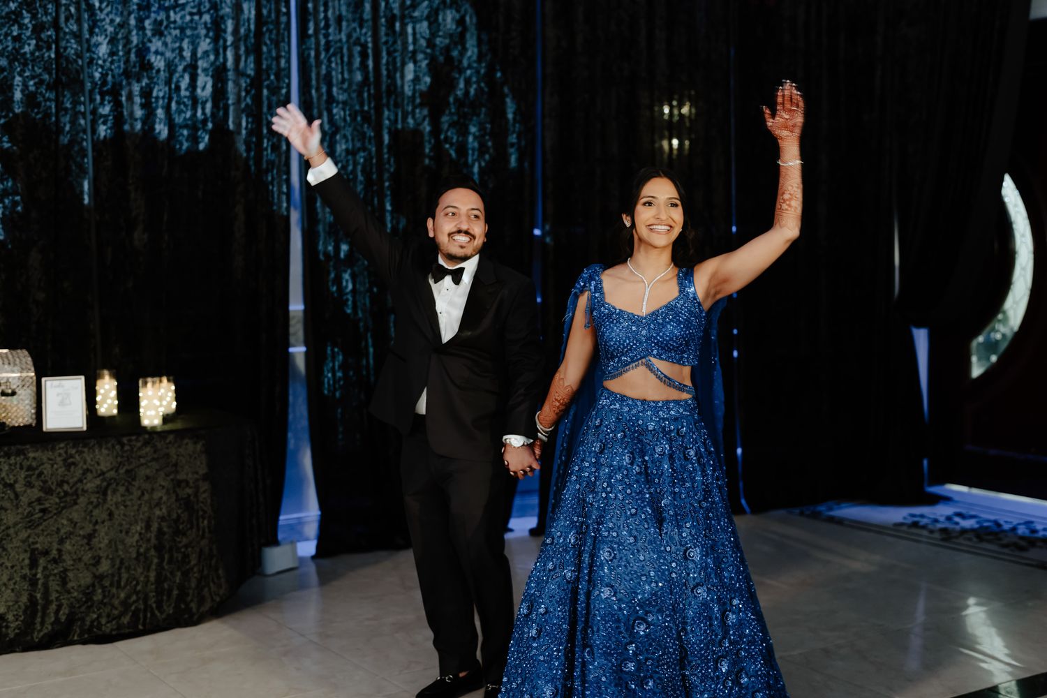 Wedding celebration with dancers in a sparkling blue gown and formal suit.