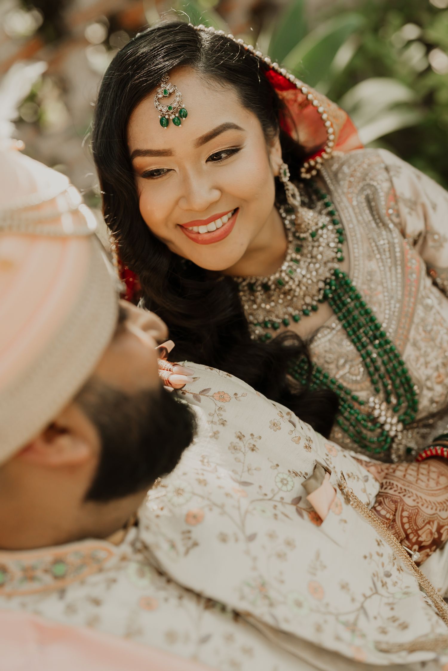 Close-up shots of a bride wearing ornate Indian jewelry and traditional bridal makeup.
