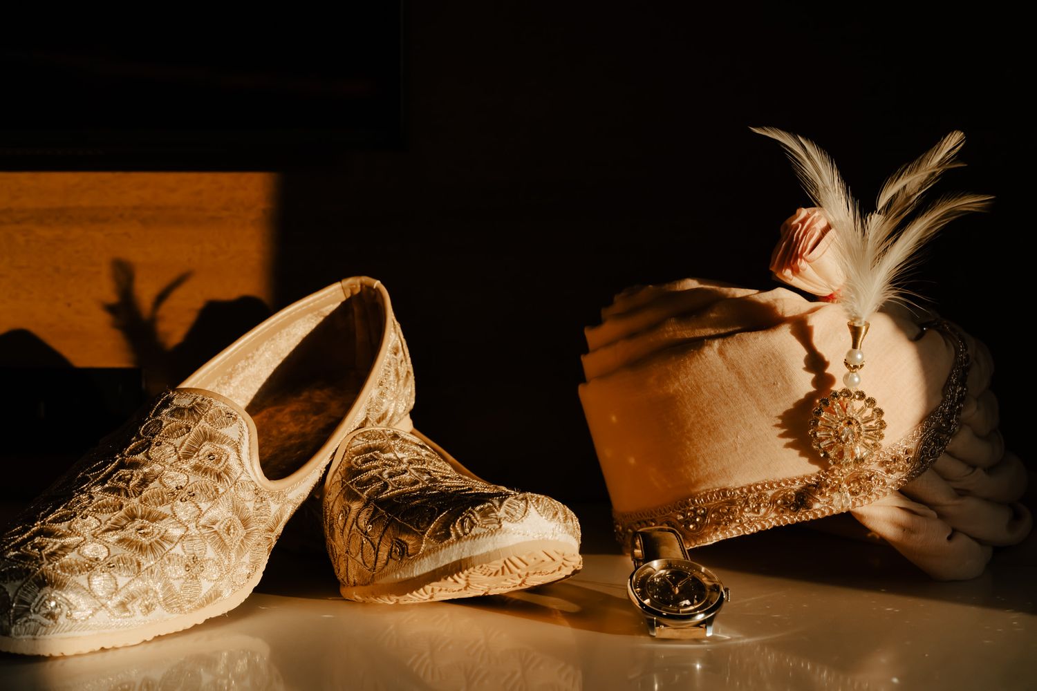 Detailed shots of ornate bridal shoes with intricate embellishments and beading in warm lighting.